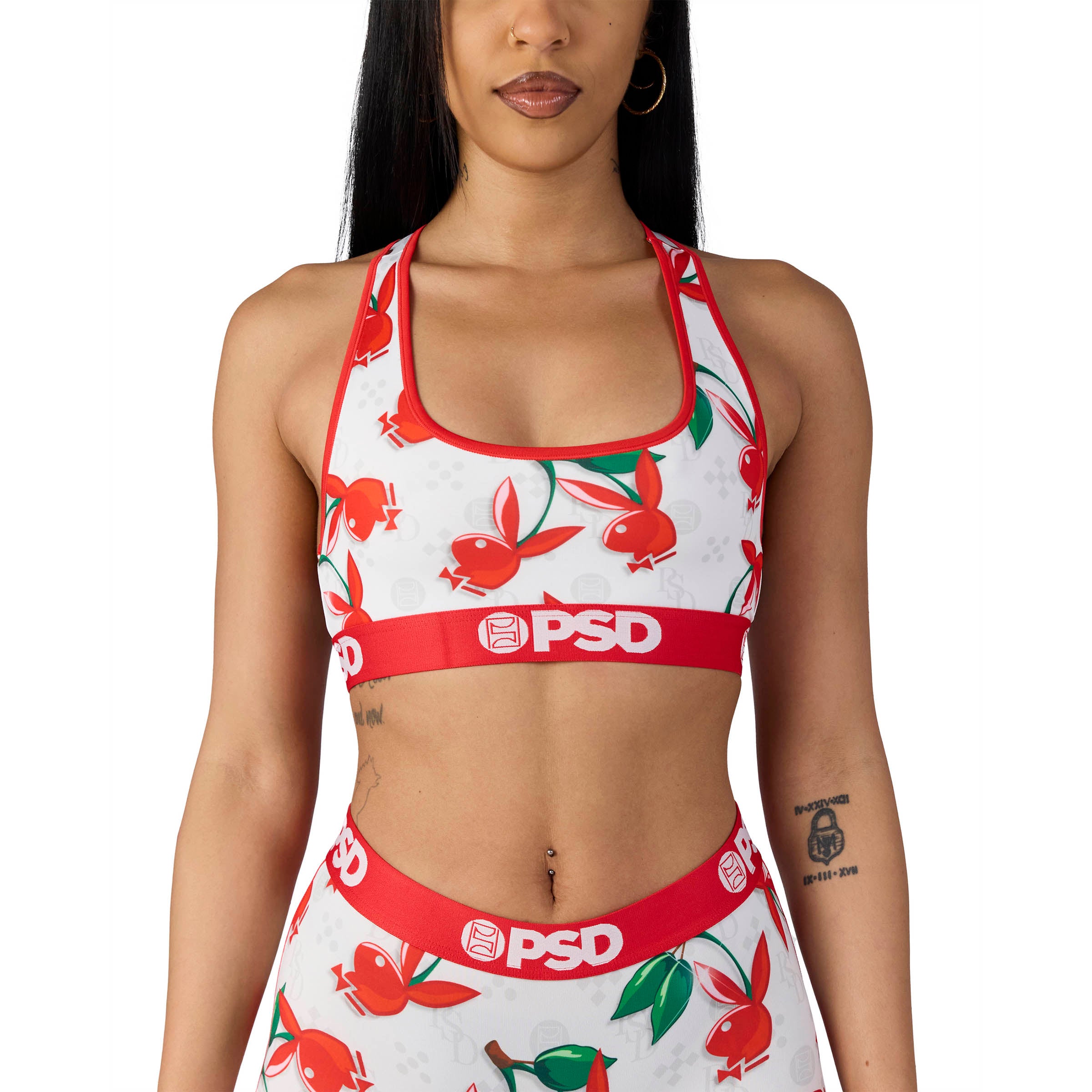 Woman wearing Playboy x PSD sports bra and shorts with red bunny logo print
