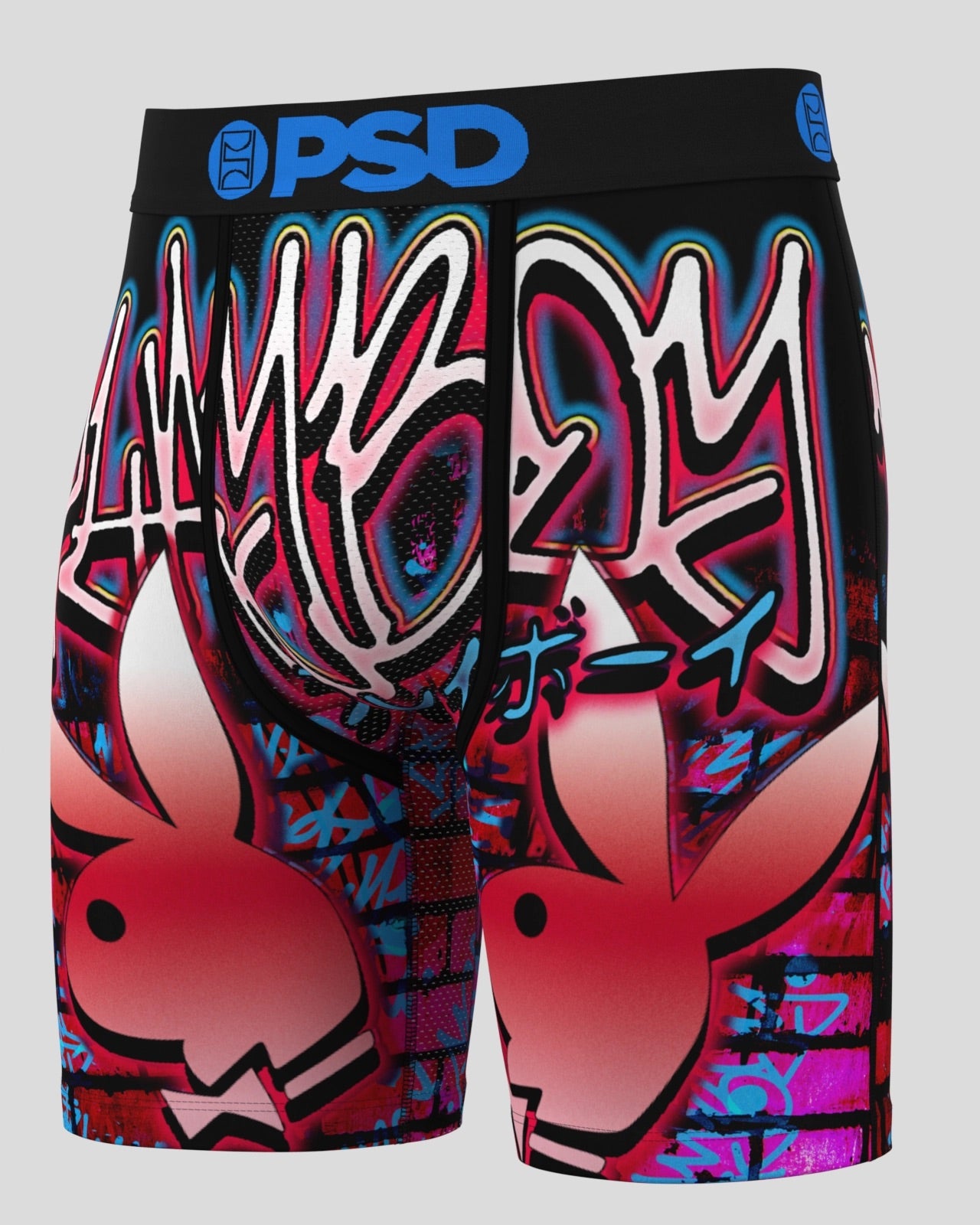 A pair of boxer briefs featuring a vibrant graffiti-style graphic print with the Playboy bunny logo and 'PSD' branding on the waistband, set against a solid light gray background.