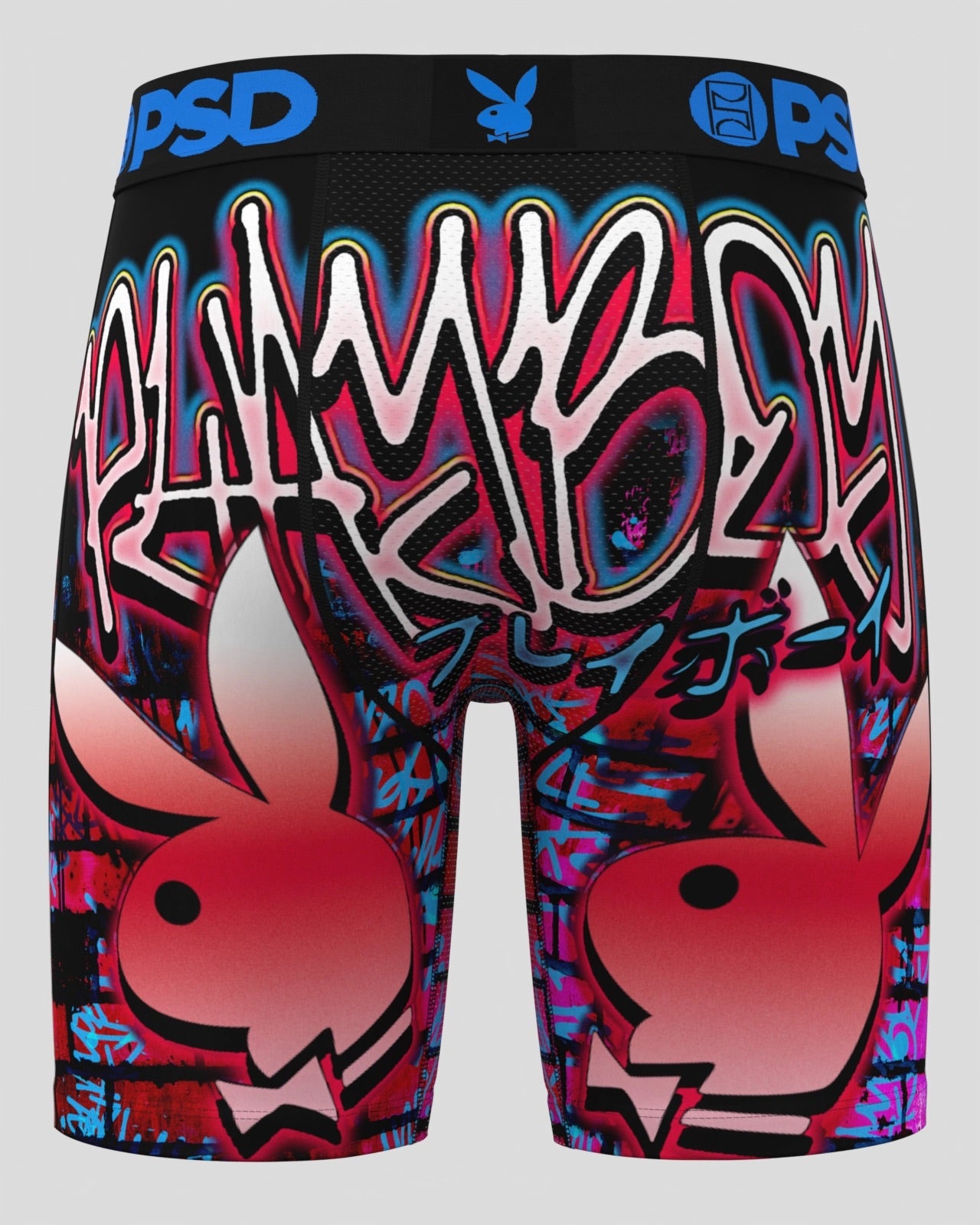 A pair of boxer briefs featuring a vibrant graffiti-style graphic print with the Playboy bunny logo, Japanese text, and blue 'PSD' branding on the waistband, shown against a solid gray background.