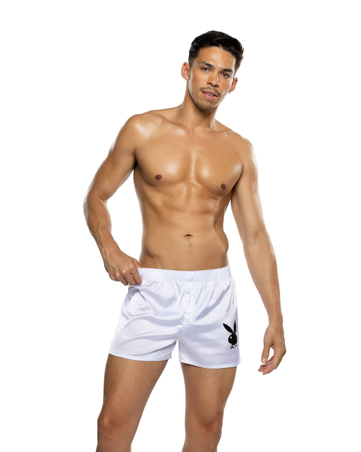 Male model wearing white boxer shorts with black bunny logo on plain background