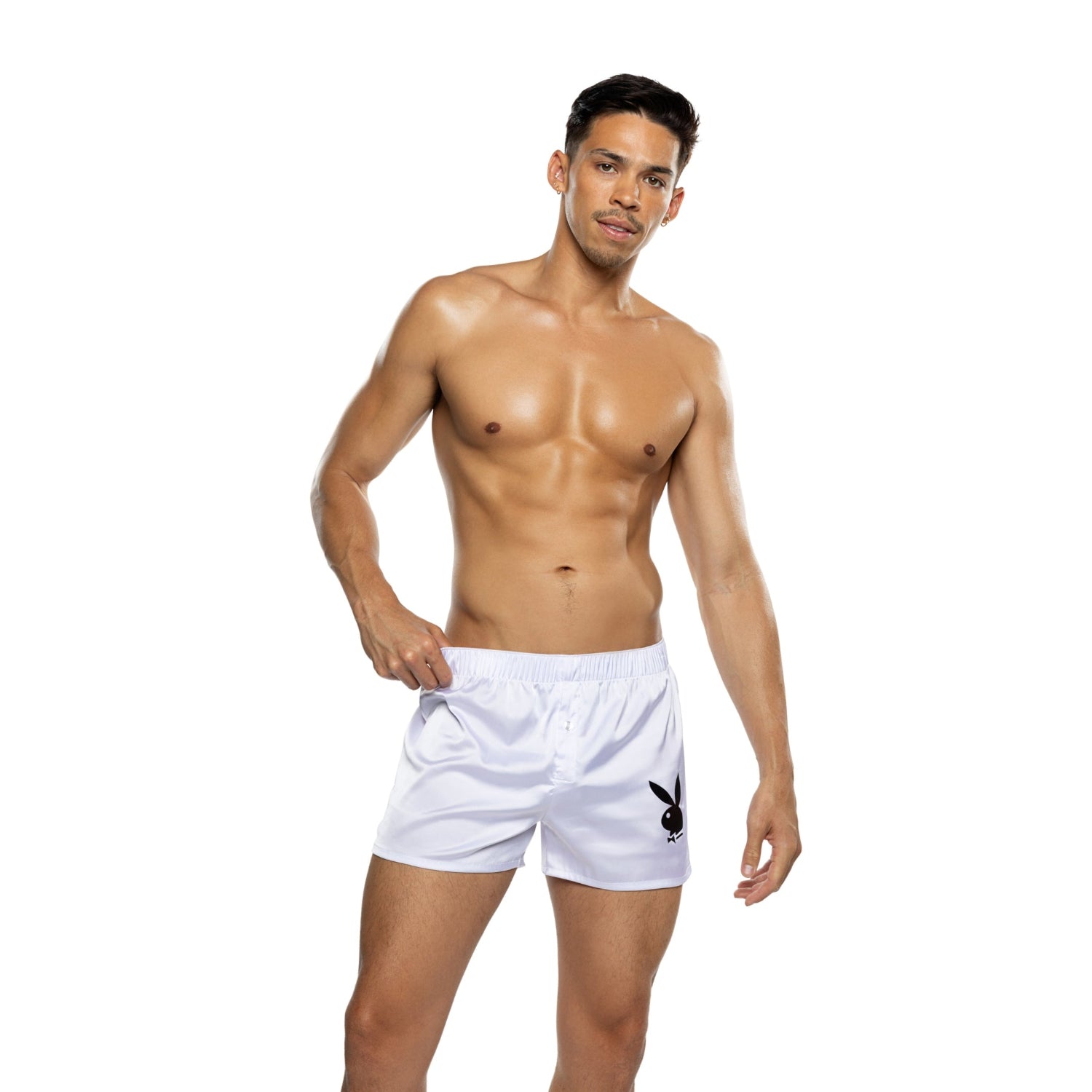 Male model wearing white boxer shorts with black bunny logo on plain background