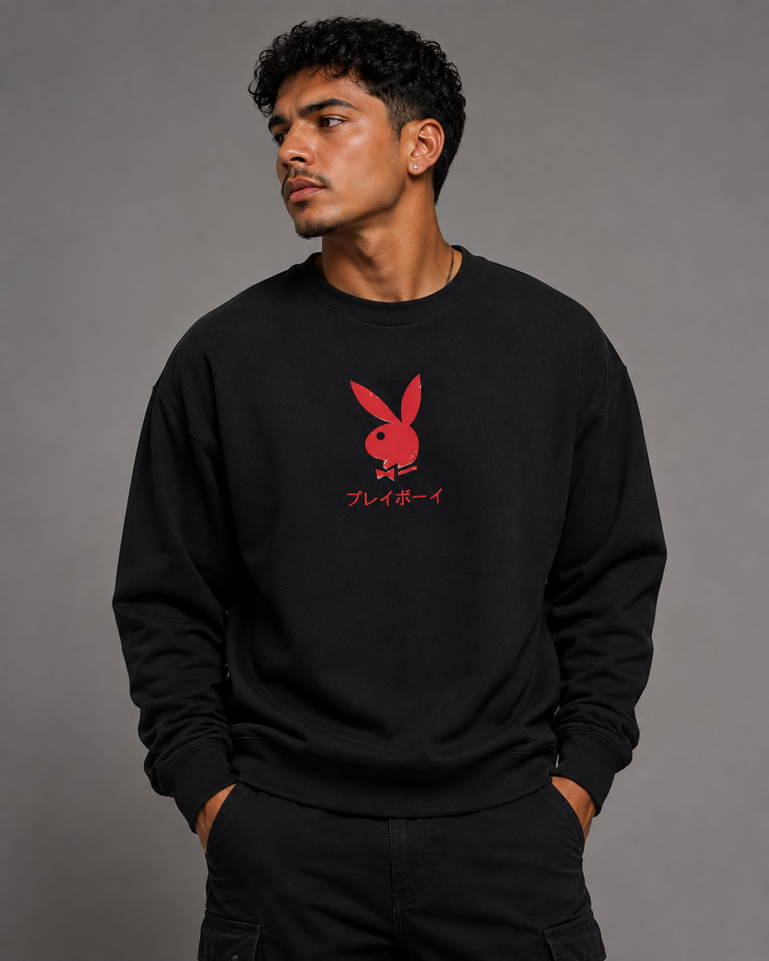 A man wearing a black crewneck sweatshirt with a red Playboy bunny logo and Japanese text on the chest, posed against a solid gray studio background. #Streetwearmen