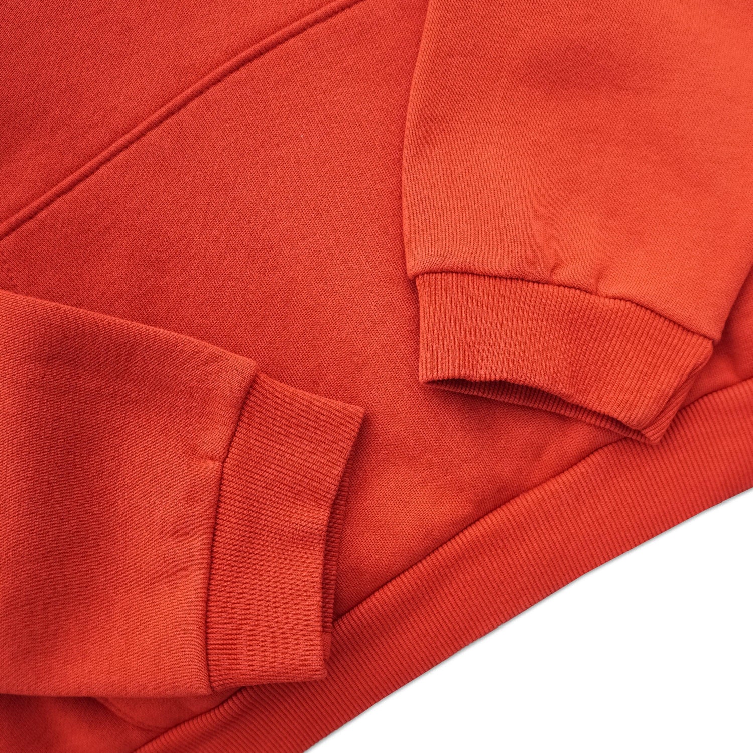 Close-up of red fleece sweatshirt with ribbed cuffs and hem