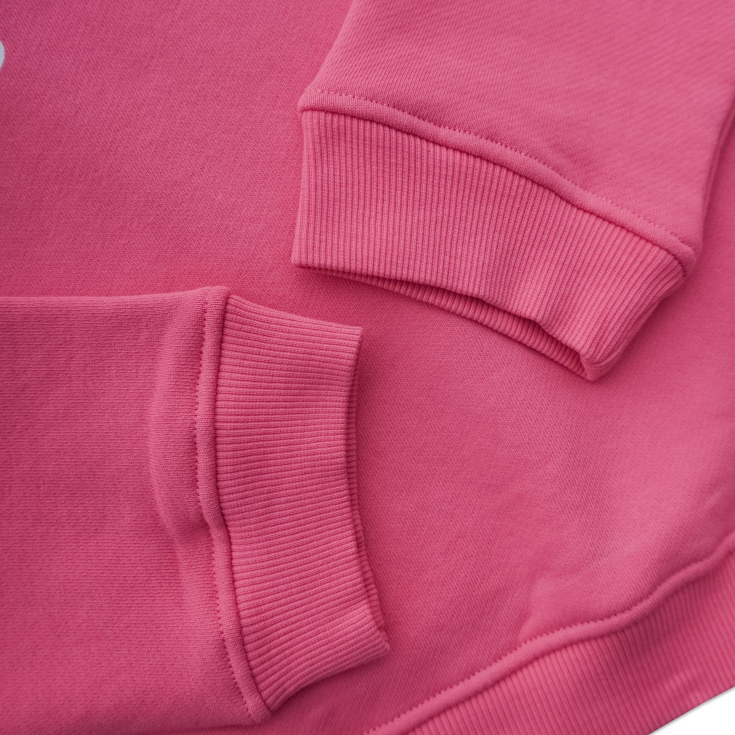 Close-up of hot pink crewneck sweatshirt cuffs and ribbed fabric detail