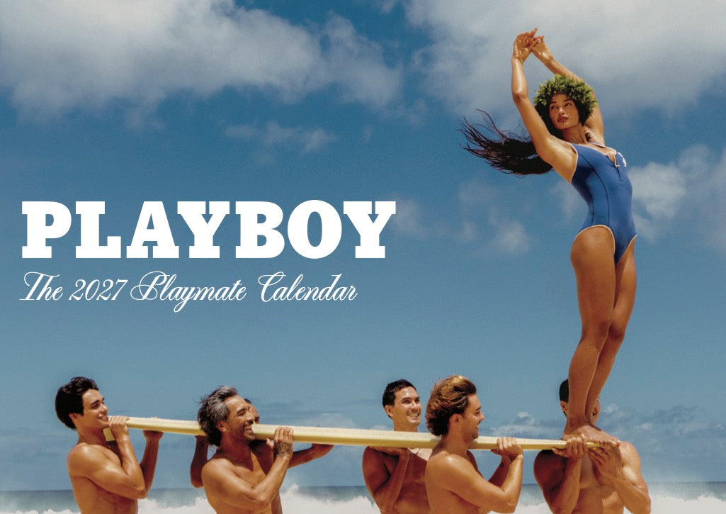 Playboy 2027 Playmate Calendar cover featuring a woman in a blue swimsuit standing on the shoulders of four men against a beach sky background, with large white PLAYBOY text and smaller white subtitle text.