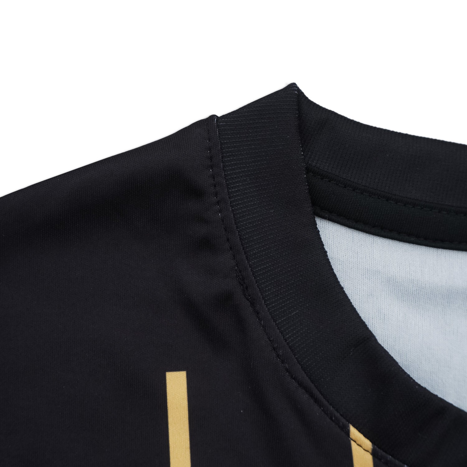 Close-up of a black garment with gold accents on a white background