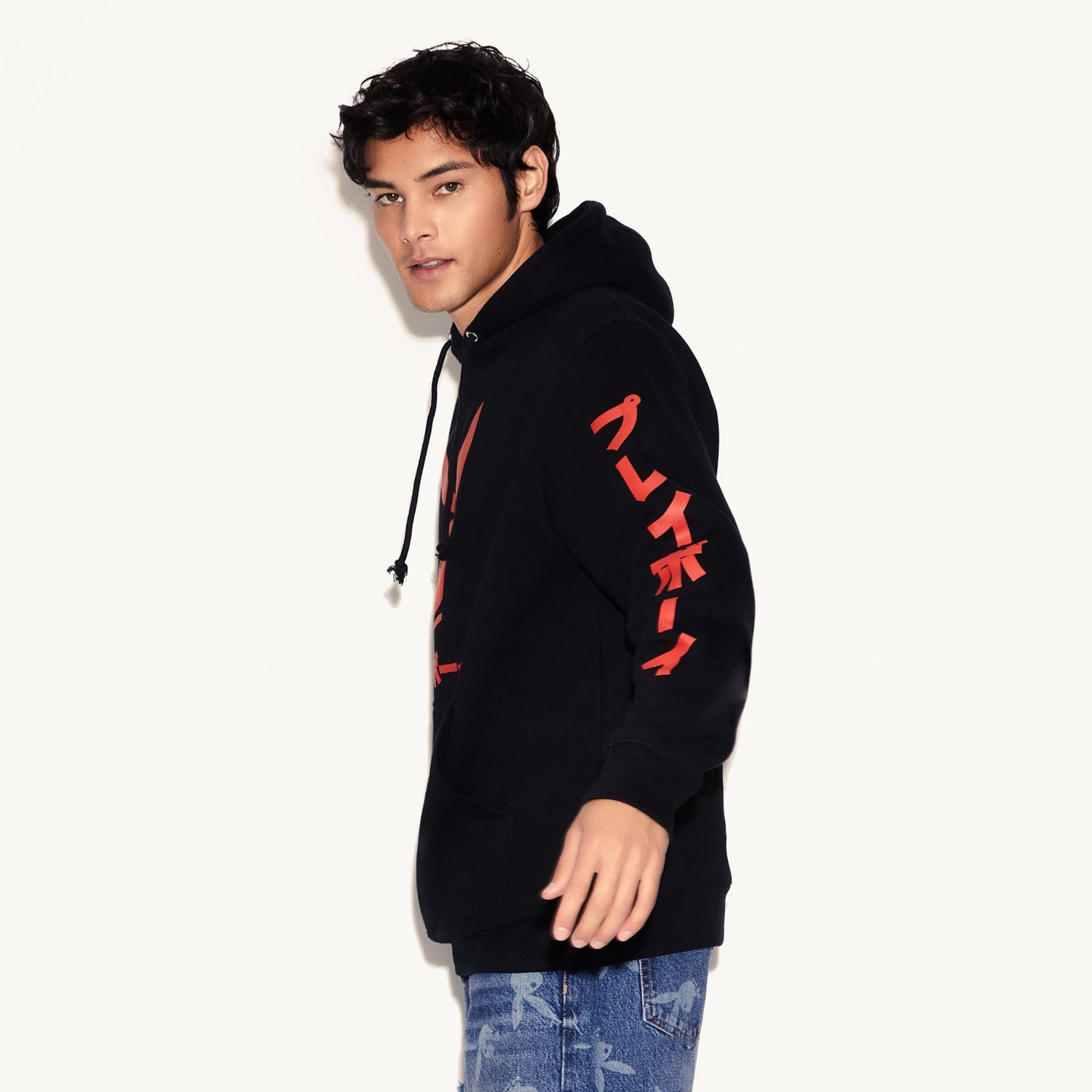 Person wearing a black hoodie with red text on a white background