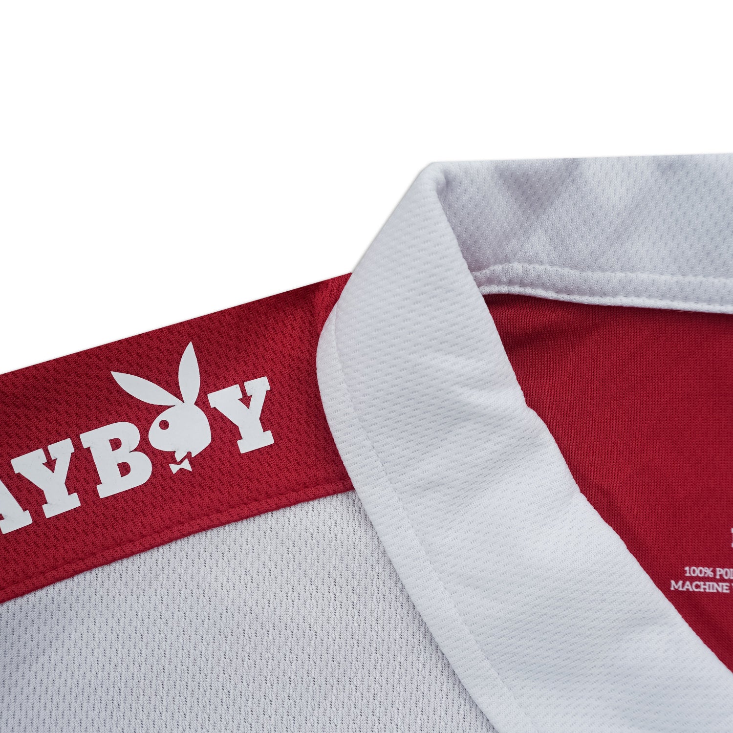 Close-up of a red and white shirt with Playboy logo on a white background