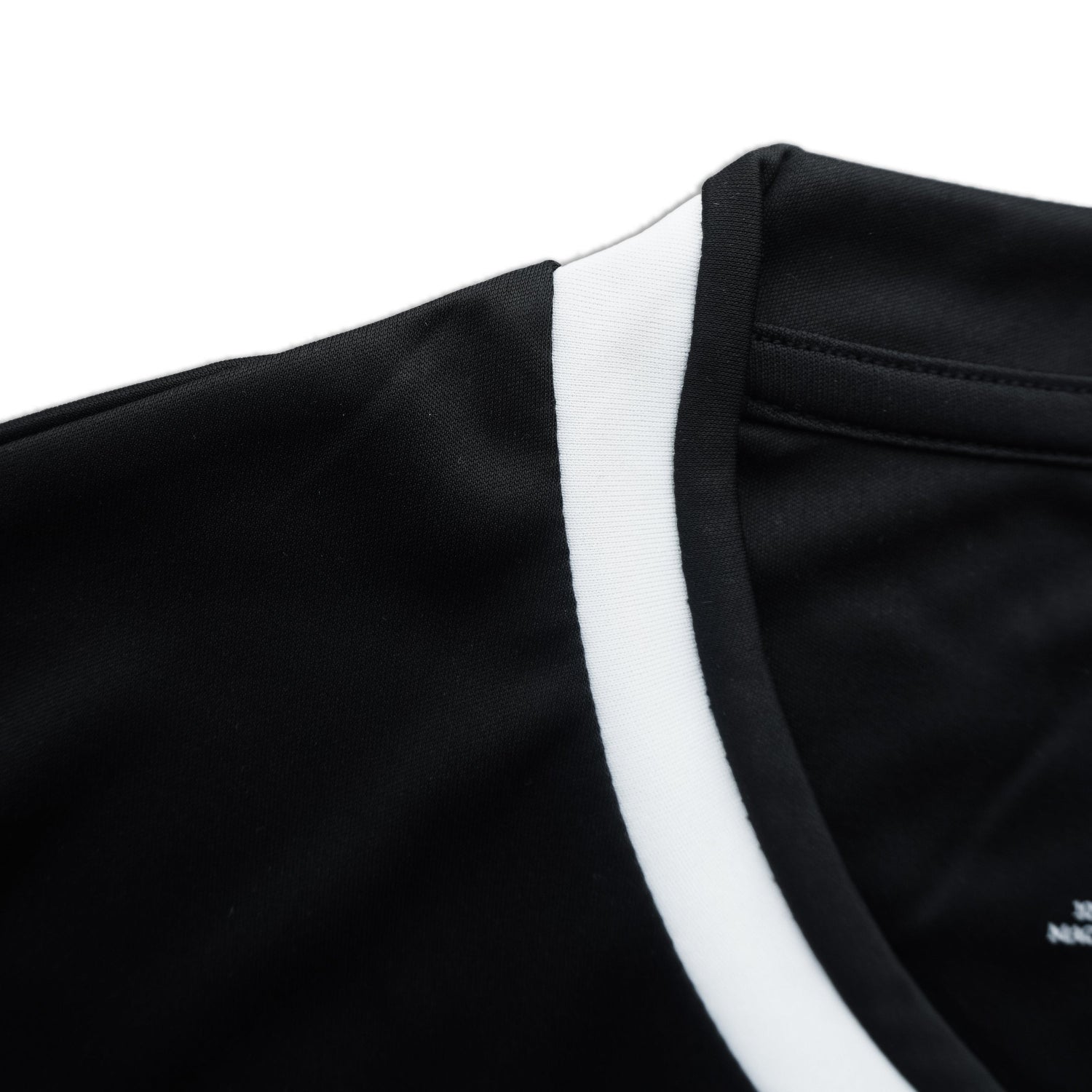 Close-up of black shorts with white trim on a white background