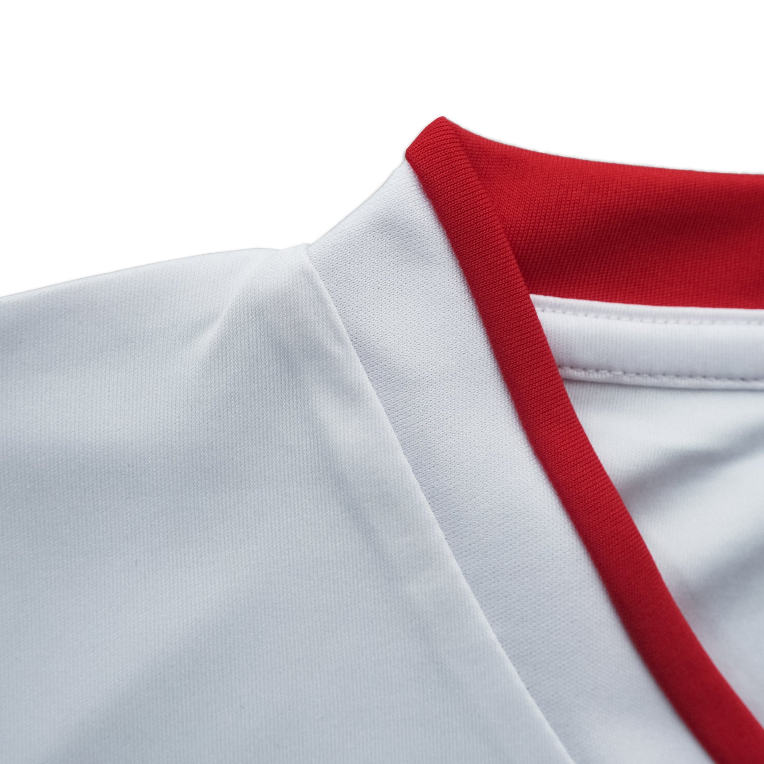 Close-up of a white garment with red trim on a white background