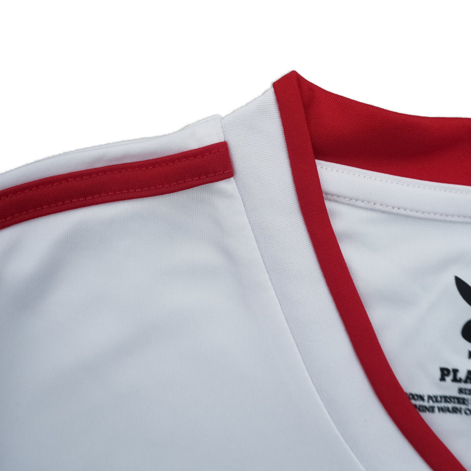 Close-up of a white sports jersey with red accents and a logo on a white background