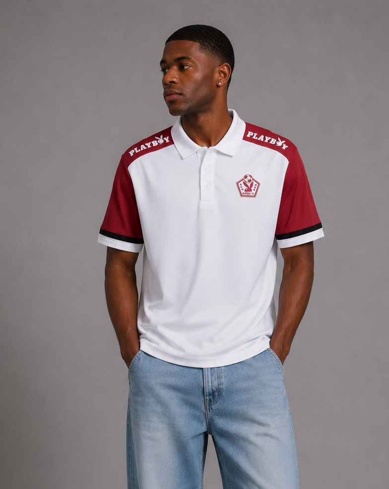 A man modeling a white and maroon short-sleeve polo shirt with 'PLAYERS' text on the shoulders, paired with light blue jeans and white sneakers, against a solid gray studio background.