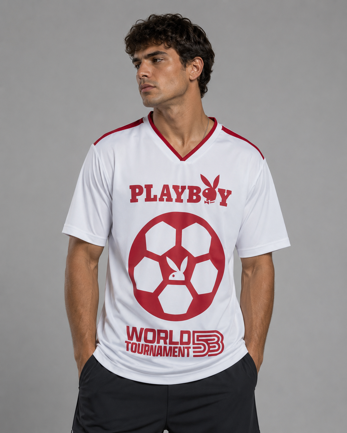 A man wearing a white short-sleeve V-neck soccer jersey with red details. The jersey features a large red Playboy logo and bunny graphic on the front, with 'PLAYBOY' and 'WORLD TOURNAMENT 5B' printed in red.
