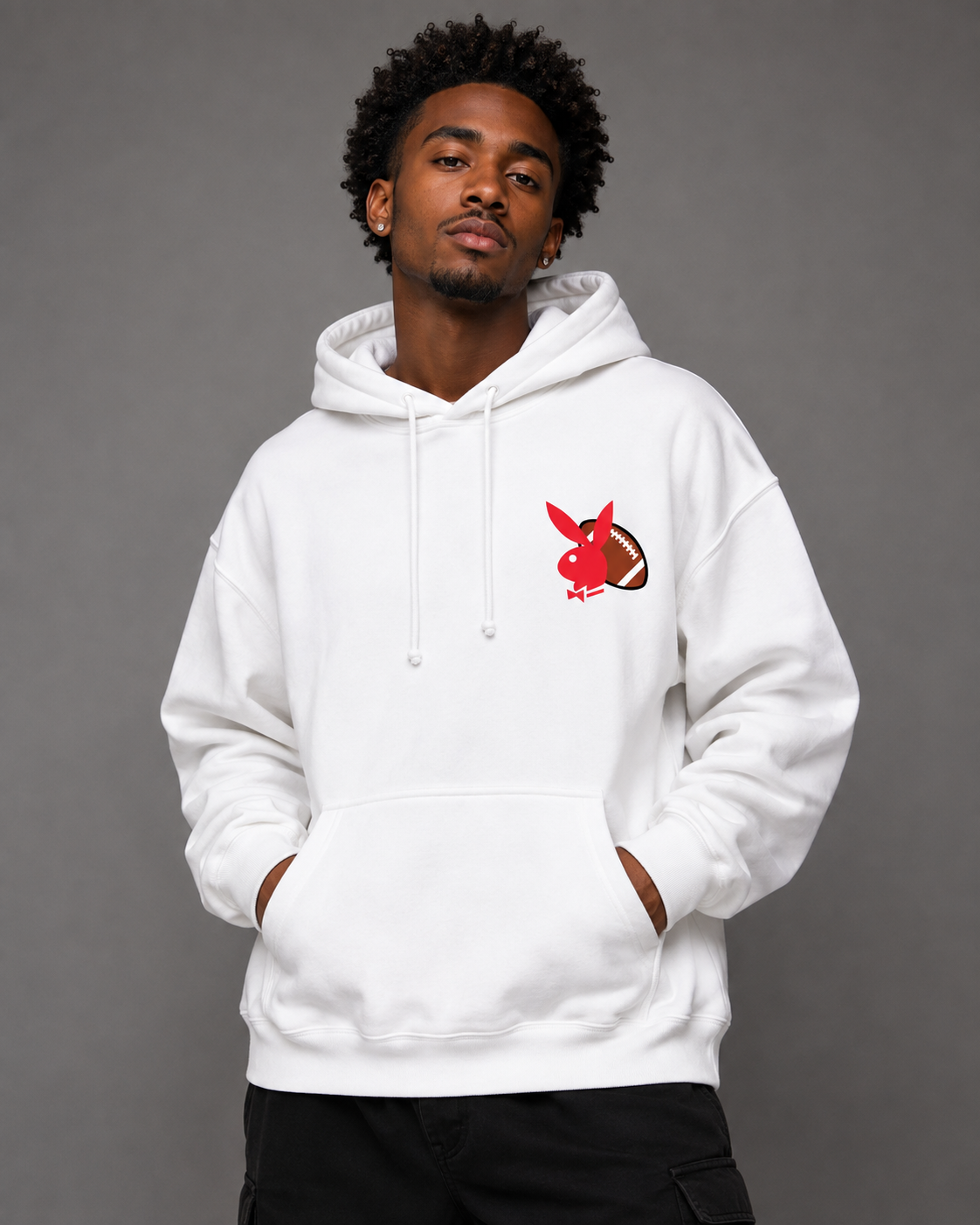 A man wearing a white pullover hoodie with a red and brown rabbit graphic on the left chest, posed against a solid gray studio background.