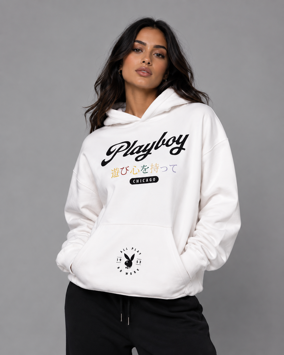 A woman wearing a white Playboy Chicago hoodie with Japanese text, hands in the front pocket, against a solid gray studio background. #Streetwearwomen