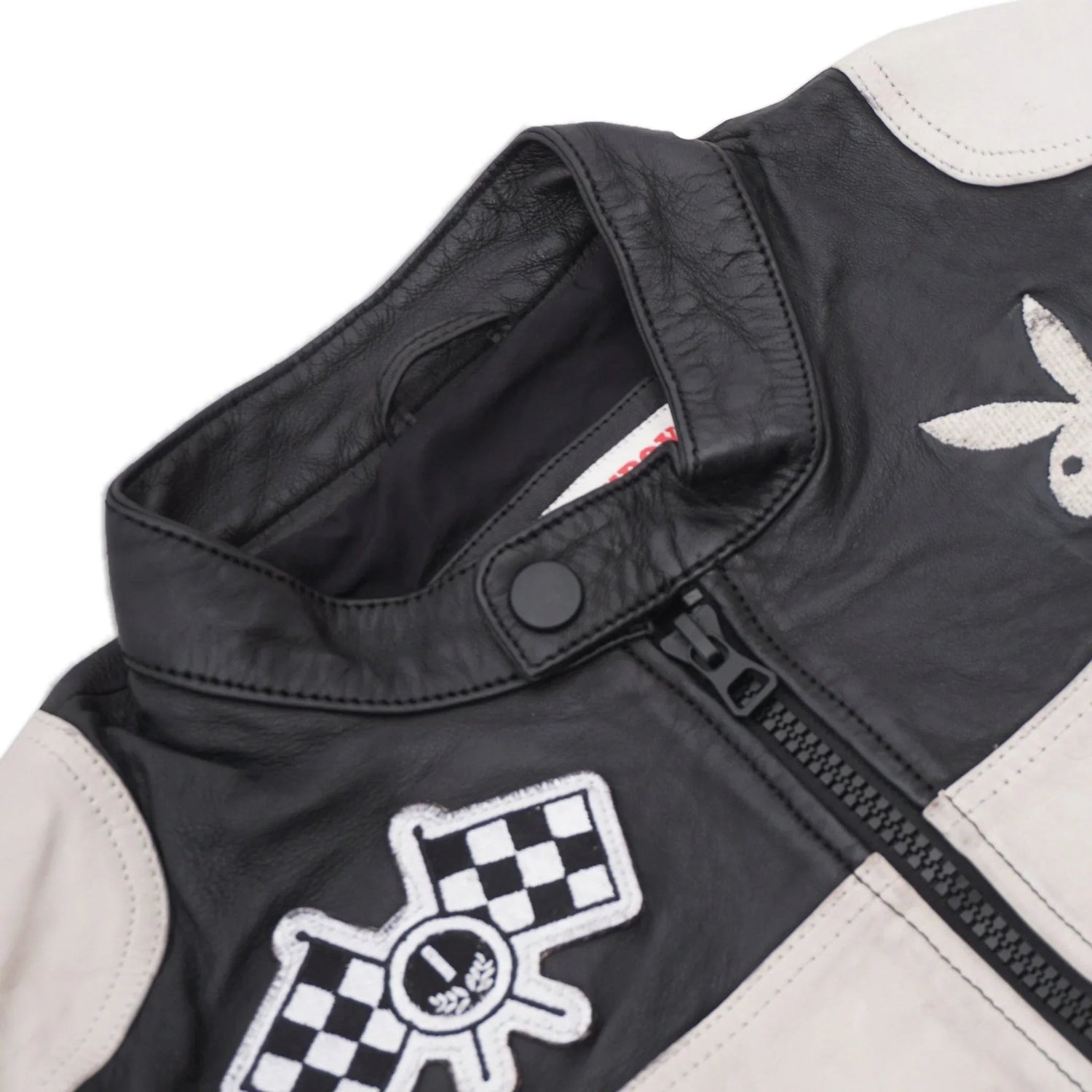 Black and white men's leather jacket with zip, snap collar, and racing patches