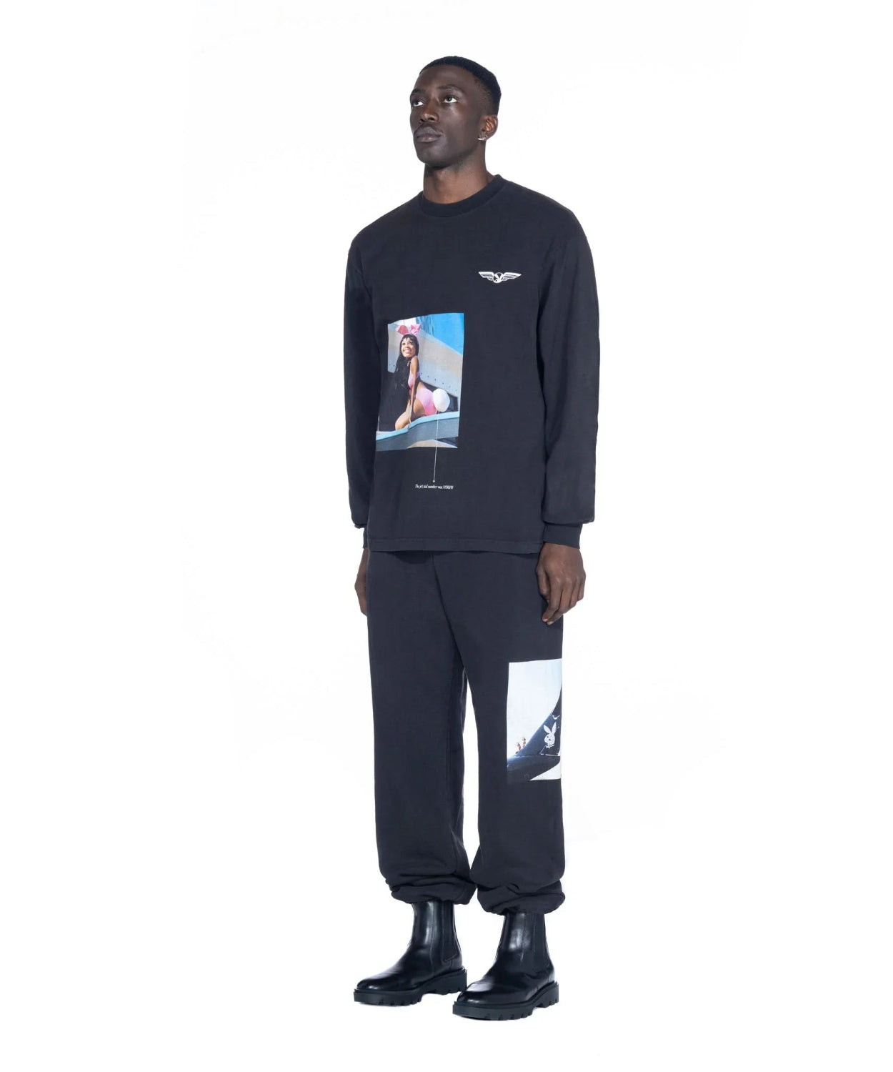 Man wearing black long sleeve graphic t-shirt and matching pants with aviation and model prints.