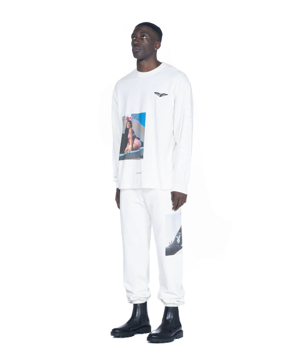 Man wearing white long sleeve t-shirt and pants with aviation-themed graphic prints
