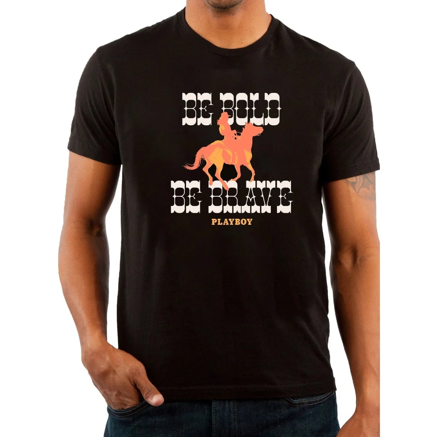 Man wearing black western graphic tee with 'Be Bold Be Brave' and cowboy on horse print.