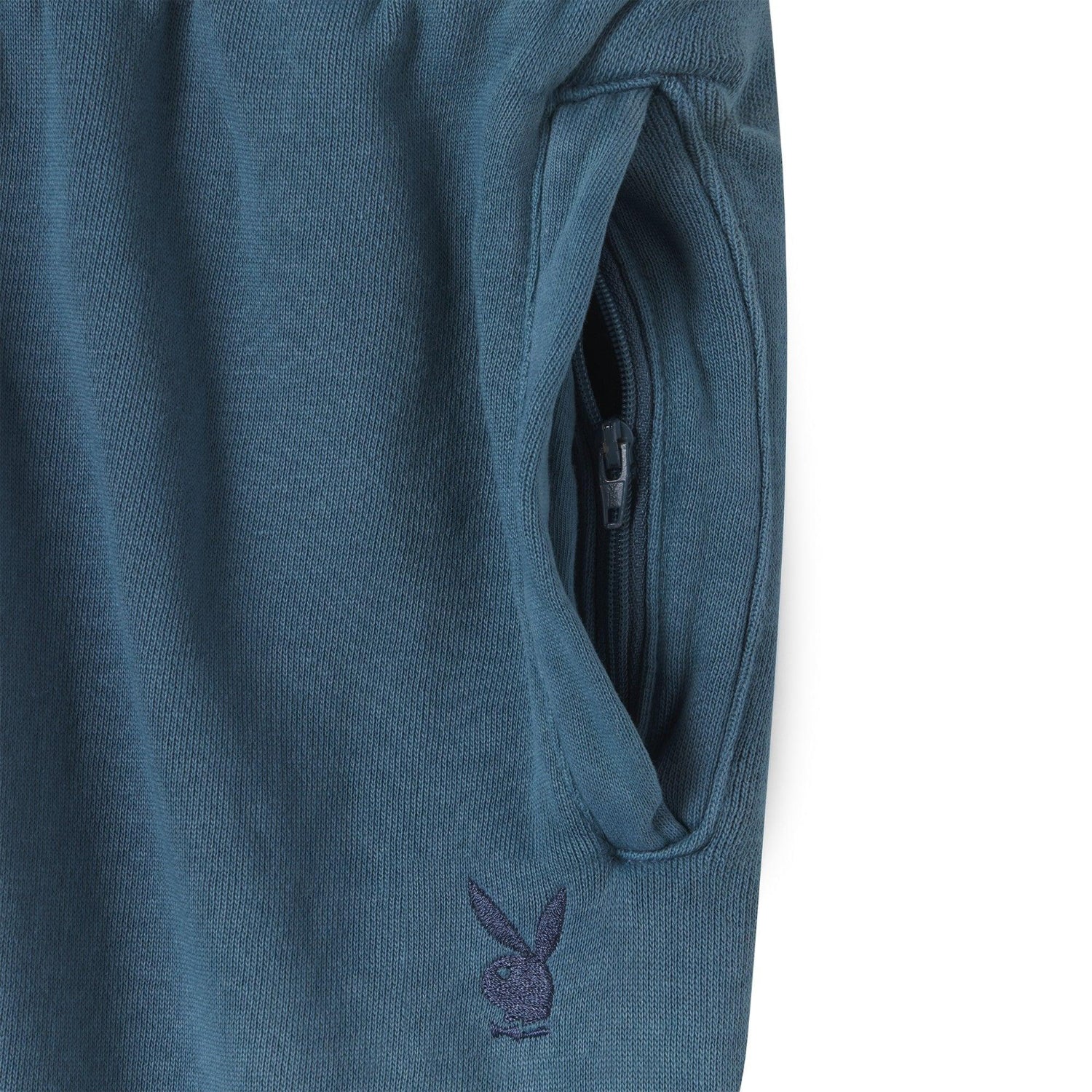 Blue sweatpants close-up with zipper pocket and embroidered bunny logo