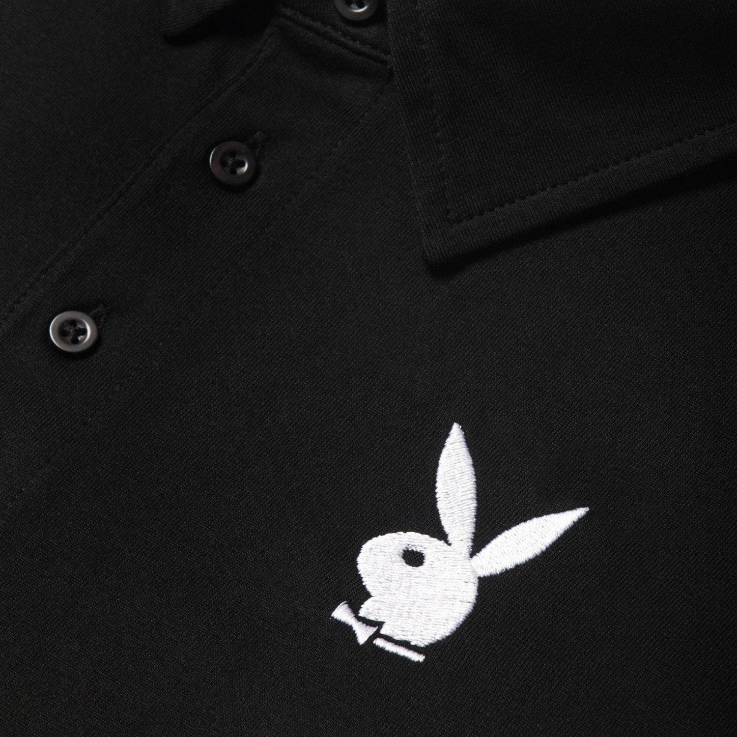 Black polo shirt with white rabbit head logo embroidery and black buttons