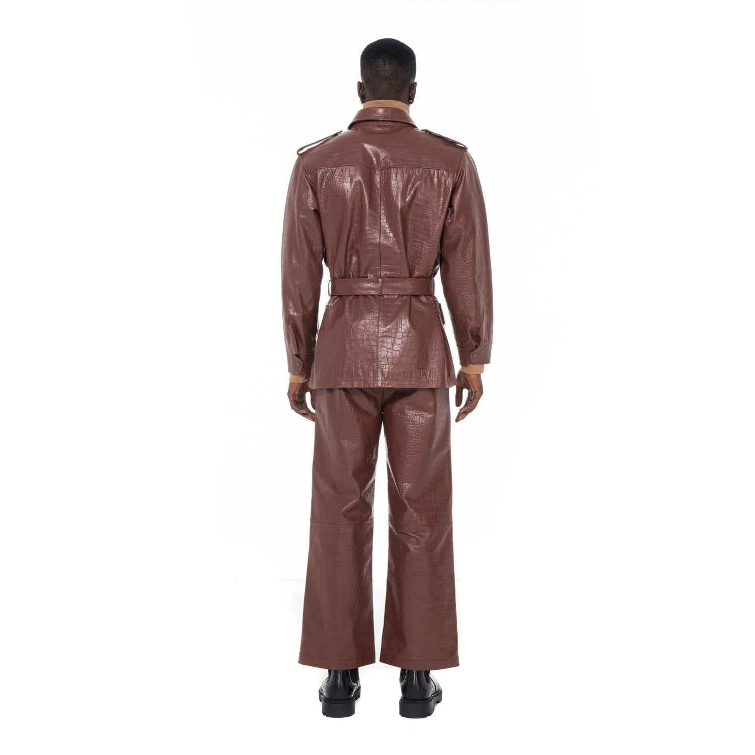 Back view of man in brown crocodile-embossed leather safari jacket and matching pants