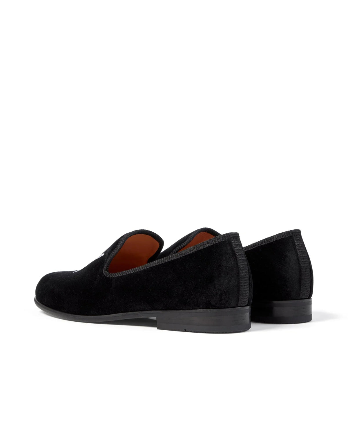 Black velvet men's loafers with low heel, photographed from the back on white background
