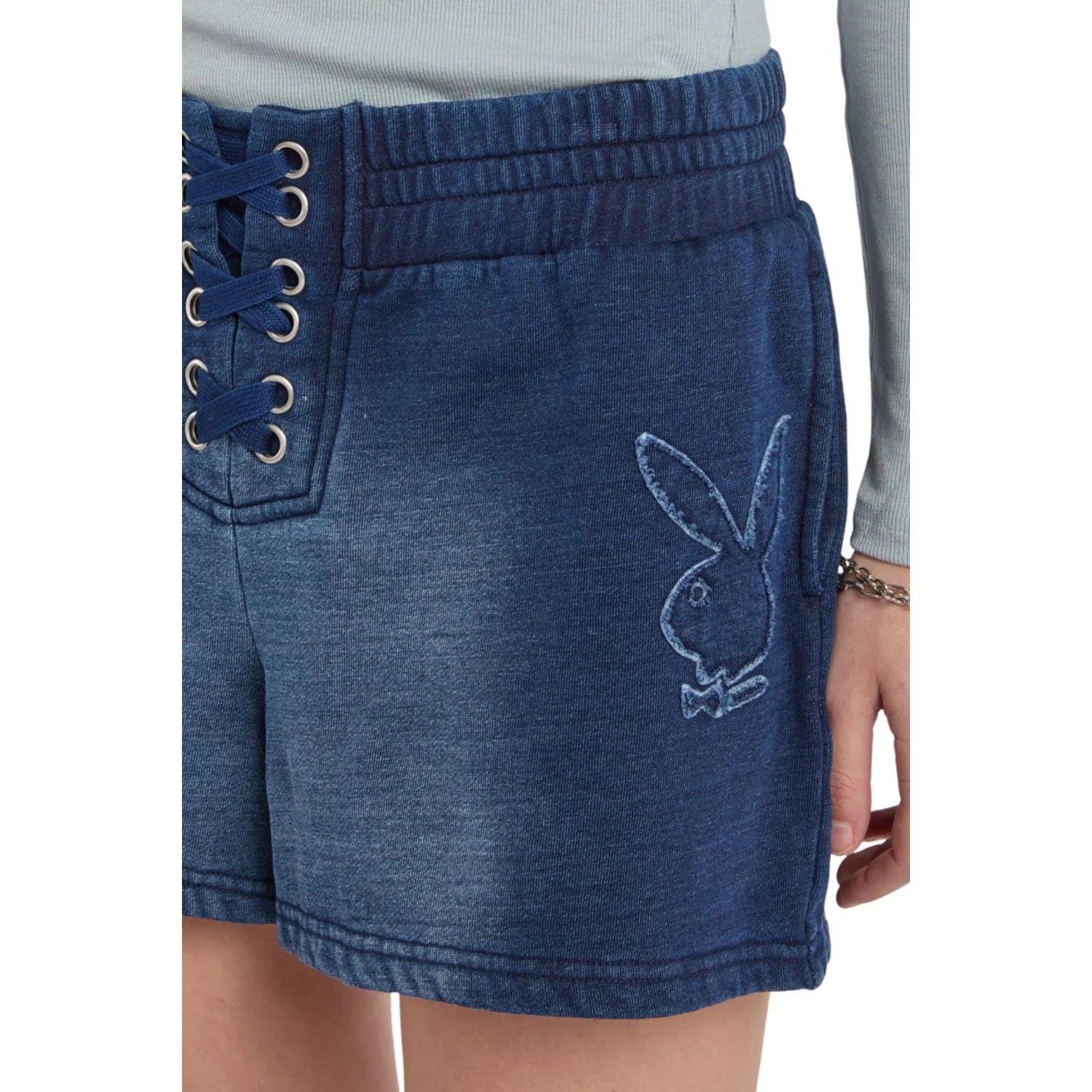 Blue lace-up denim shorts with embroidered bunny logo, modeled by a person