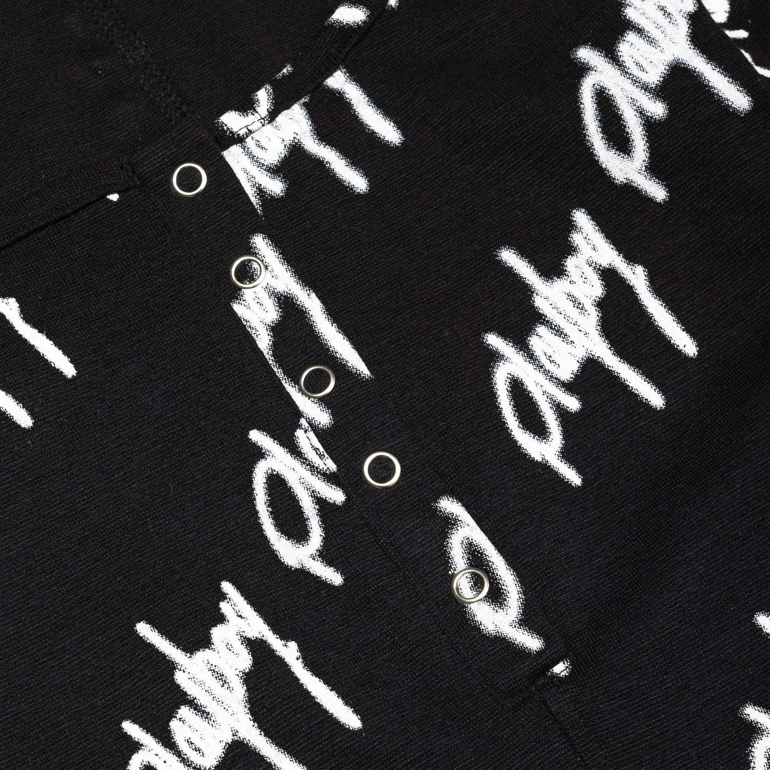 Black playsuit with white graffiti script print and snap button detail