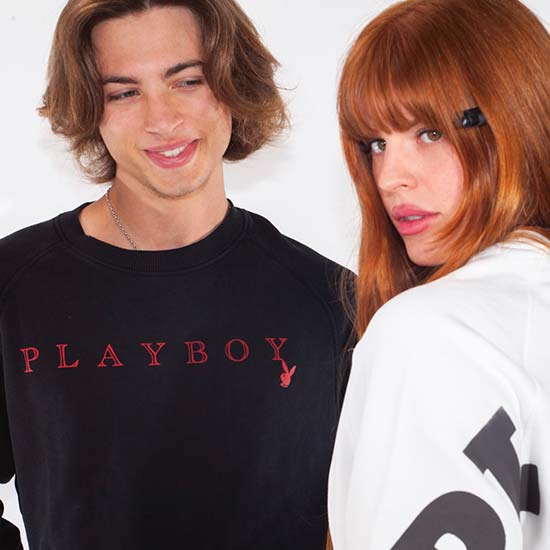 Couple wearing white Playboy sweaters