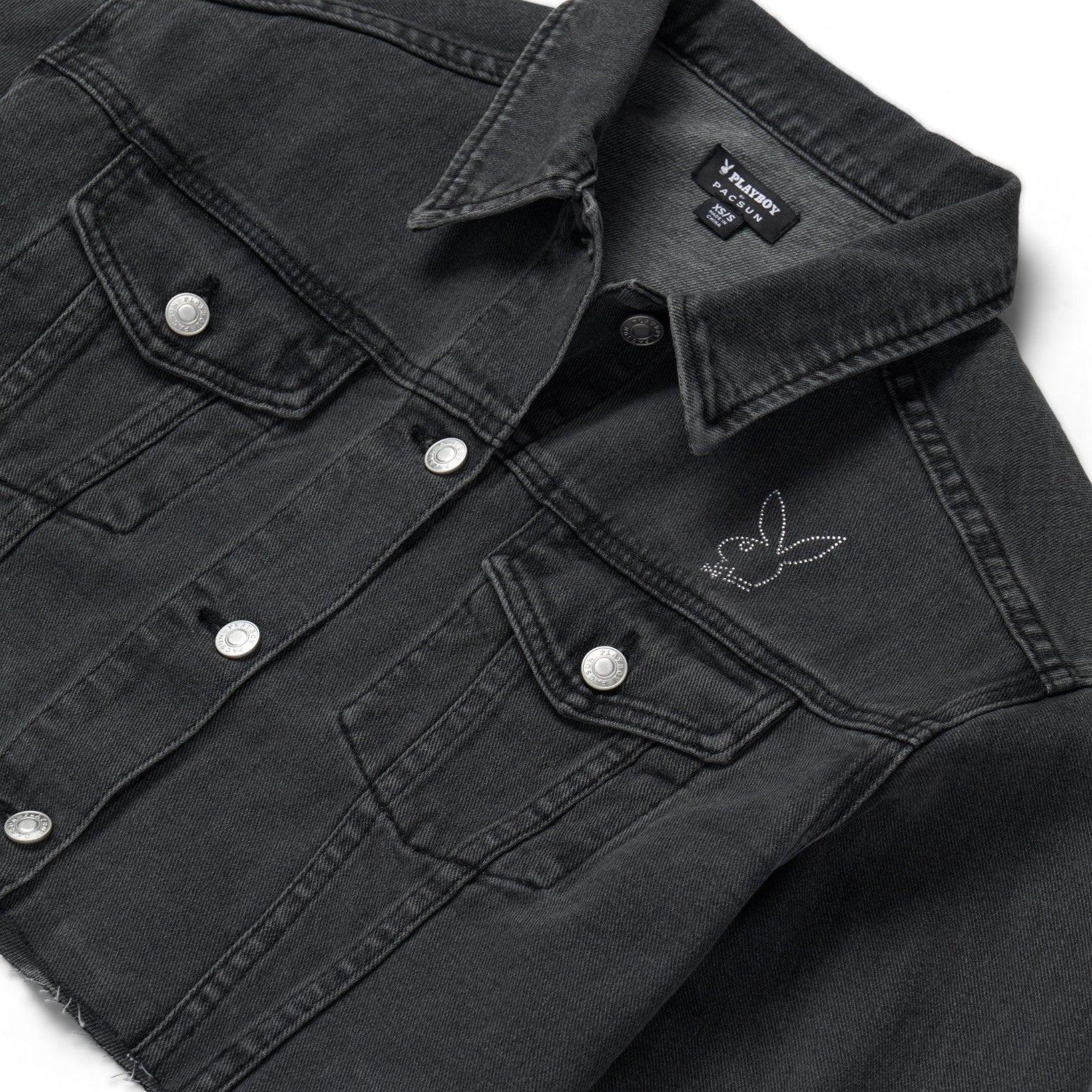 Black denim jacket with rhinestone bunny logo on chest and metal snap buttons
