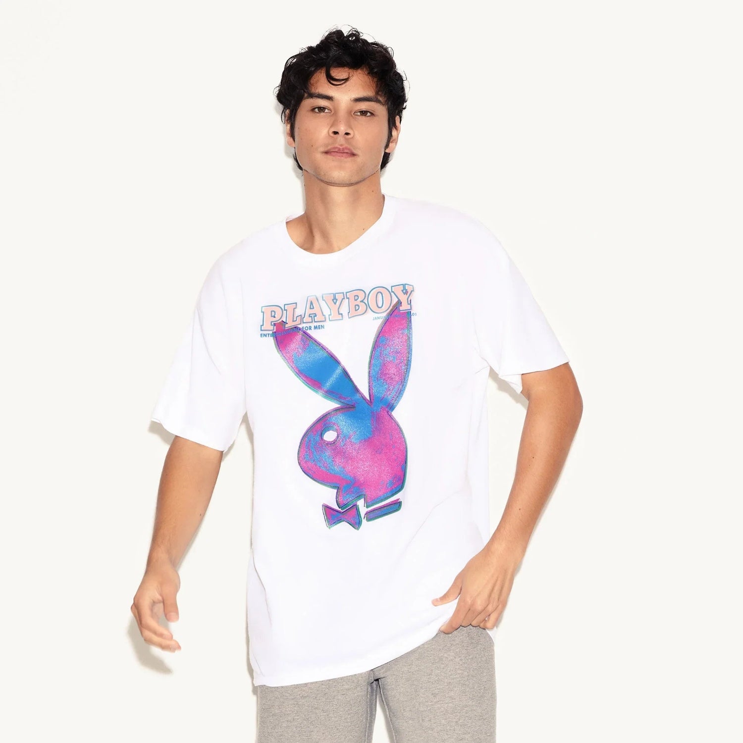 Man wearing white t-shirt with colorful pop art graphic and large bunny logo on front