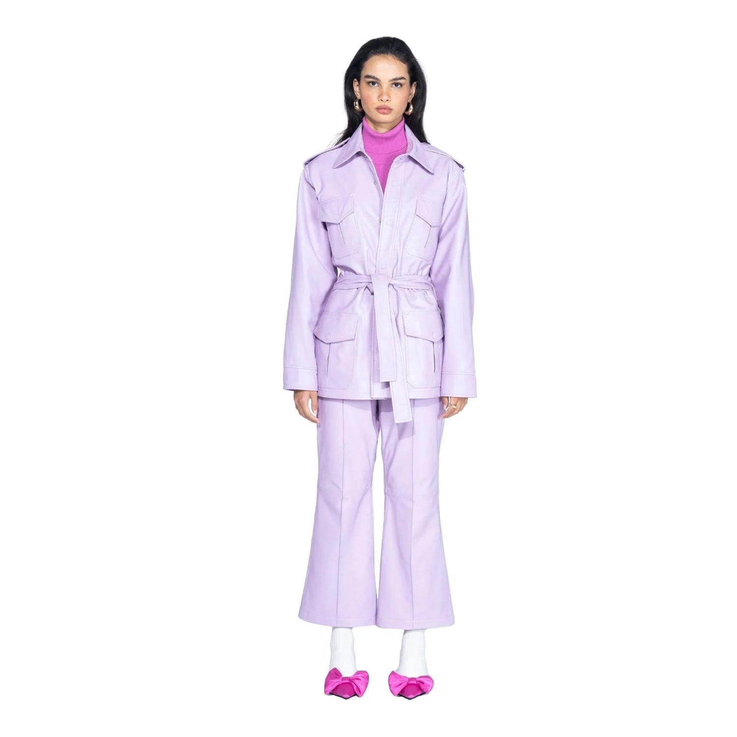 Woman wearing lilac leather safari jacket with belt, matching pants, and pink heels