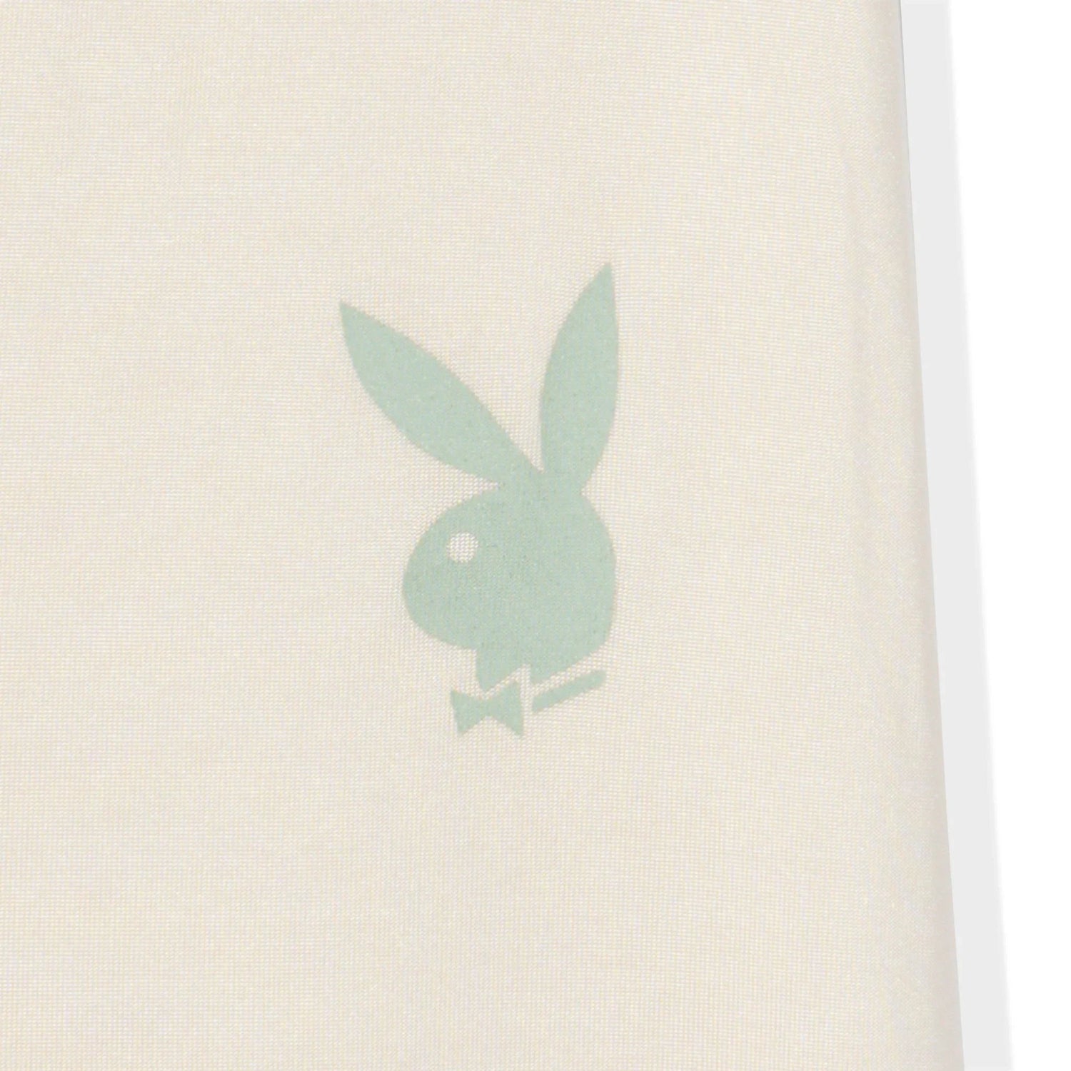 Cream leggings close-up with green bunny head logo, soft lifestyle activewear fabric