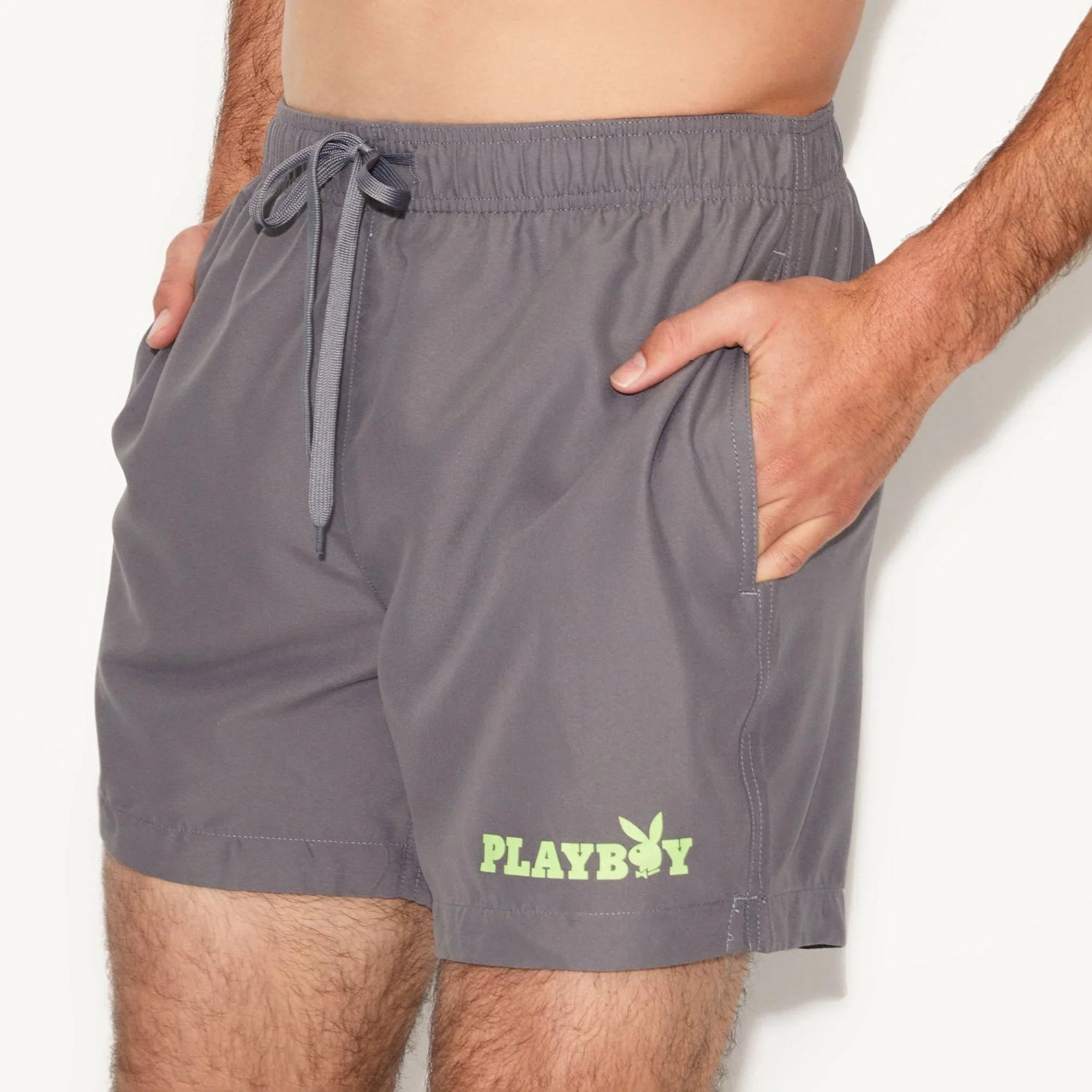 Men's gray swim trunks with elastic waistband, drawstring, side pockets, and neon logo