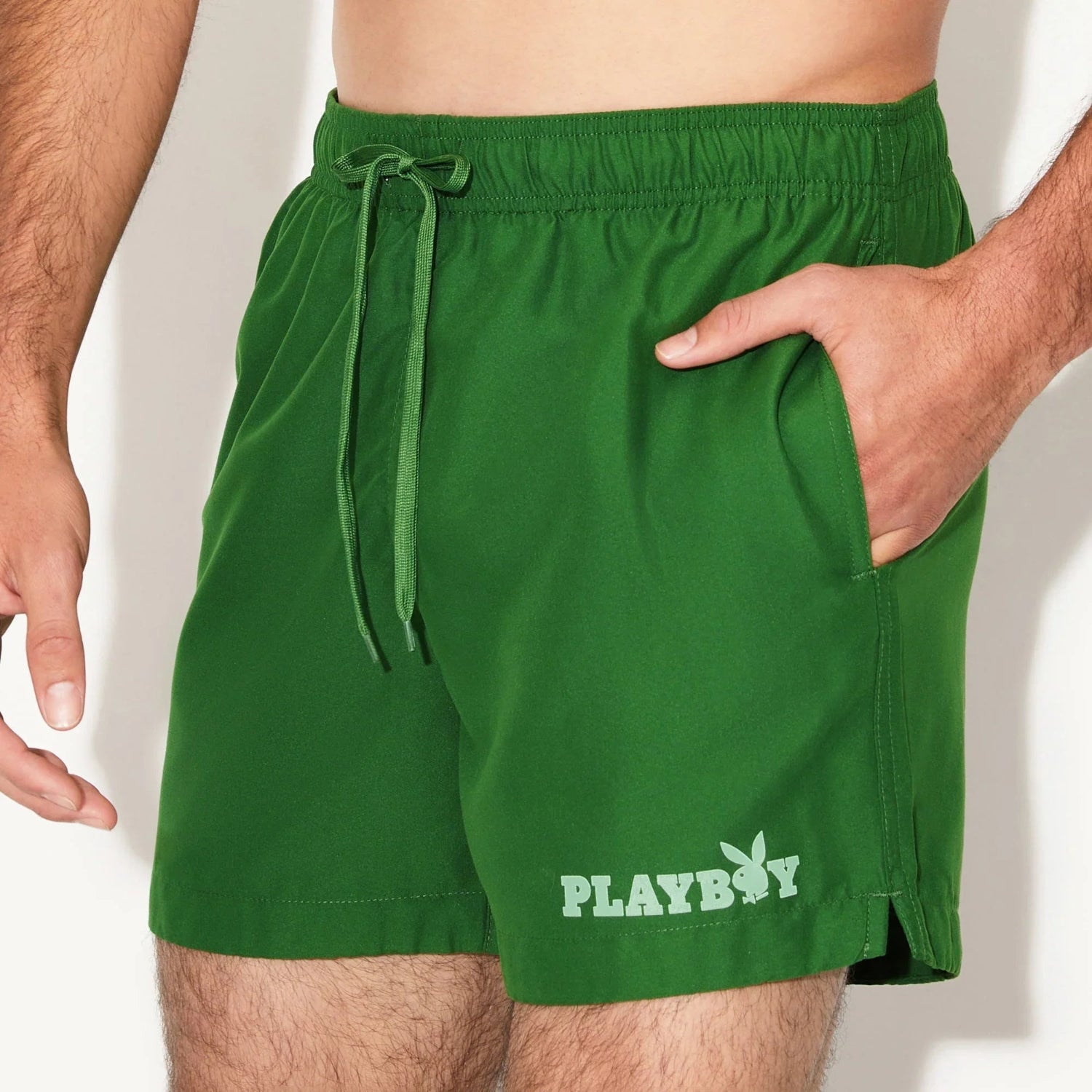Green men's swim trunks with drawstring waist and logo on left leg