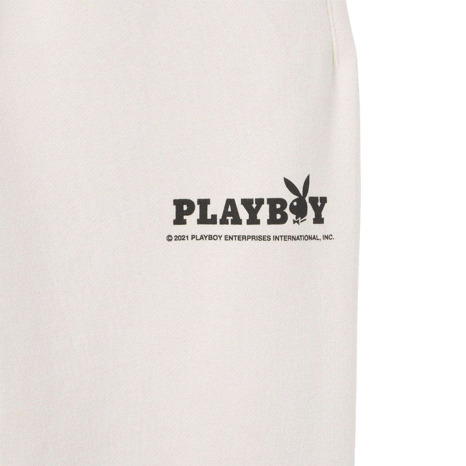 Cream men's sweatpants with black PLAYBOY logo graphic on upper thigh.