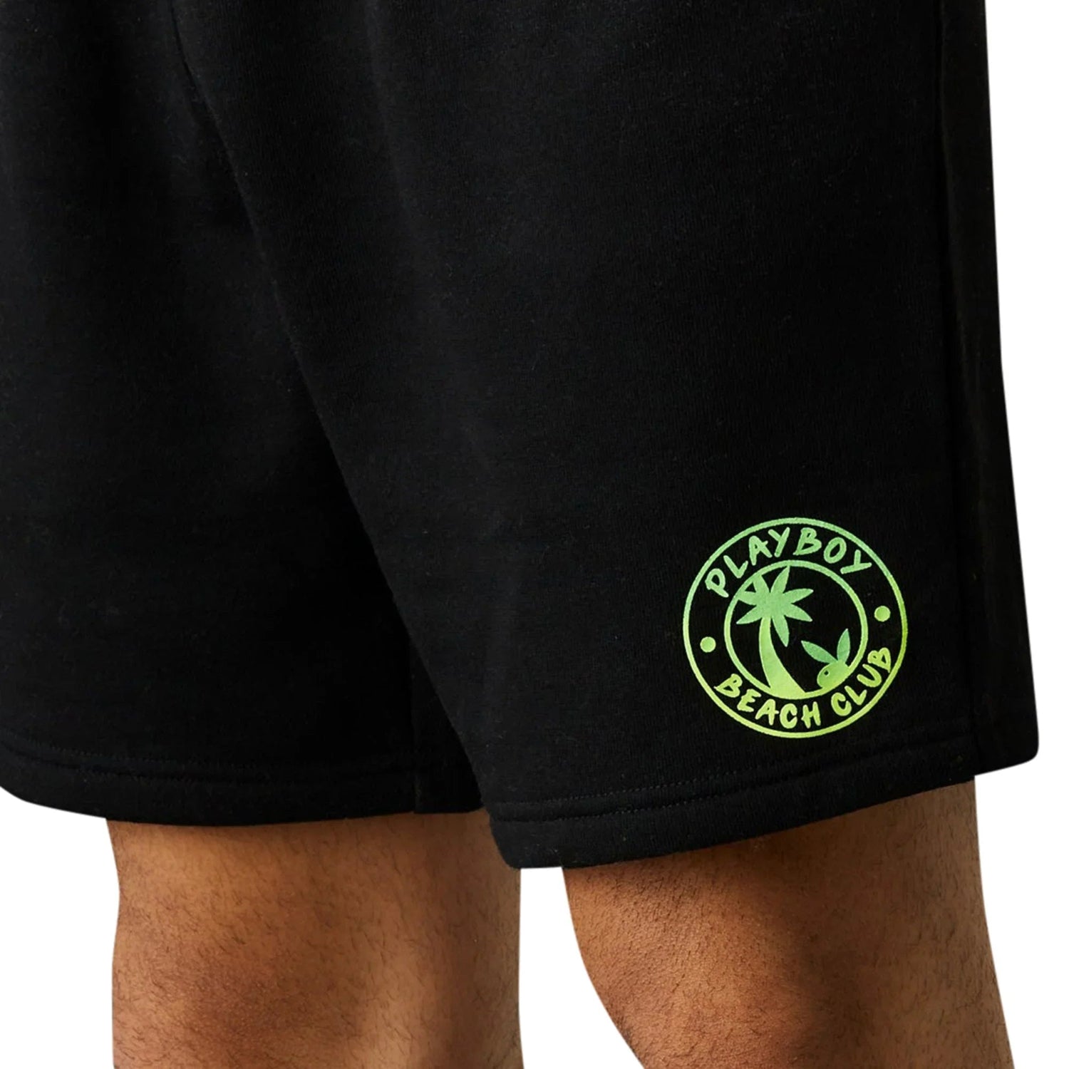 Men's black shorts with neon green Playboy Beach Club palm tree graphic