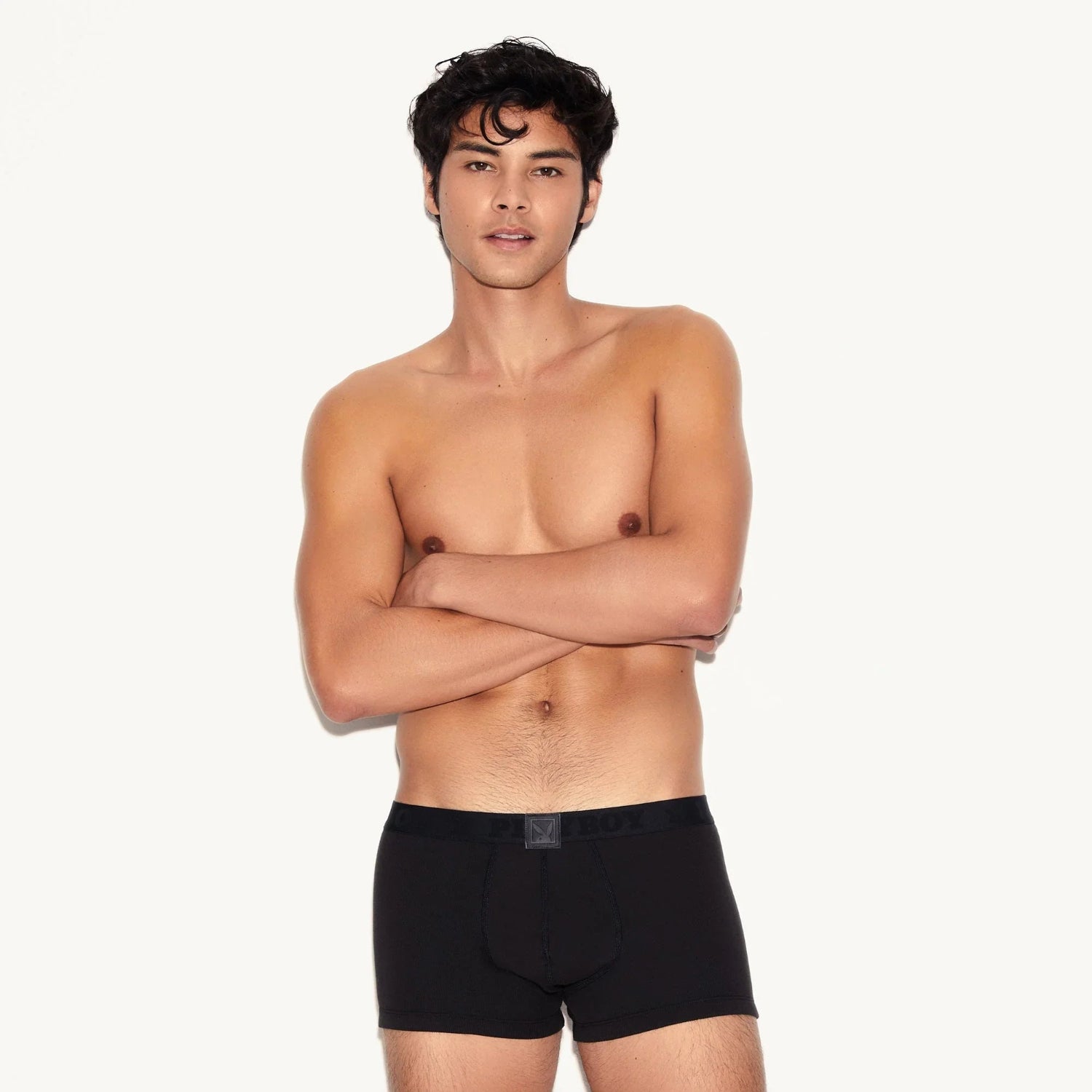 Male model wearing black ribbed men's trunk underwear against white background
