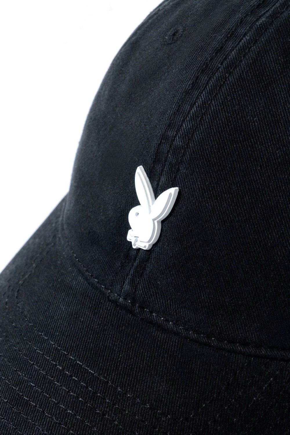 Black dad hat with metal rabbit head pin on front crown, minimalist unisex cap