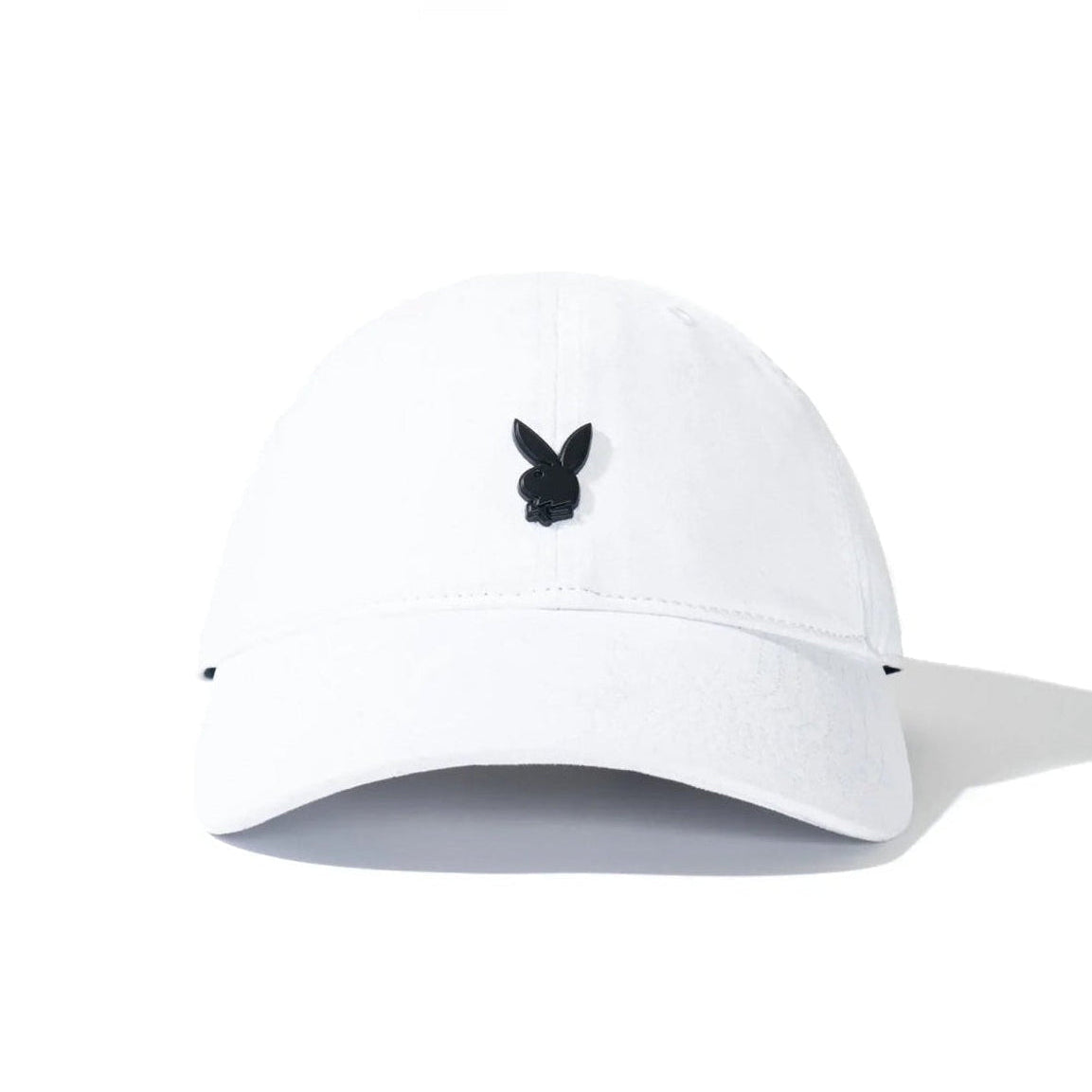 White dad hat with black metal rabbit head pin on front, minimalistic accessory