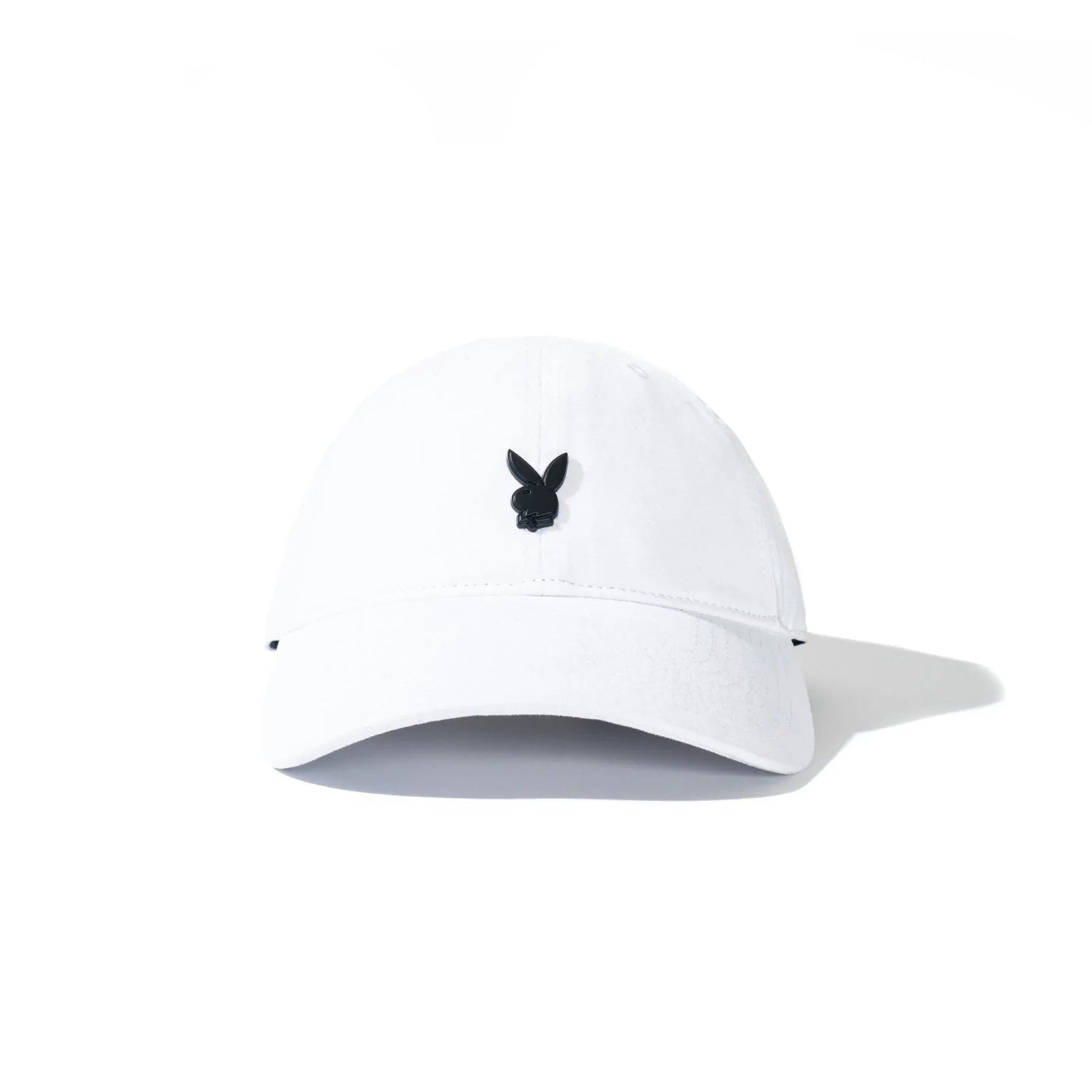 White dad hat with black metal rabbit head pin on front, minimalistic accessory