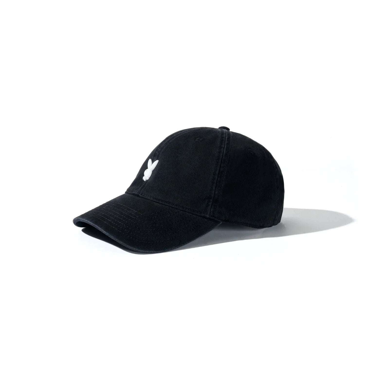 Black dad hat with white metal rabbit head pin on front, minimalist unisex accessory