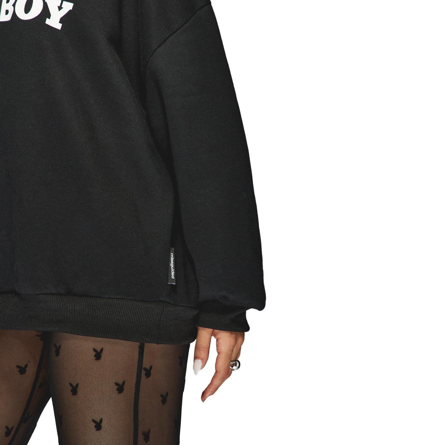 Black oversized hoodie with white text, paired with sheer tights featuring bunny logos