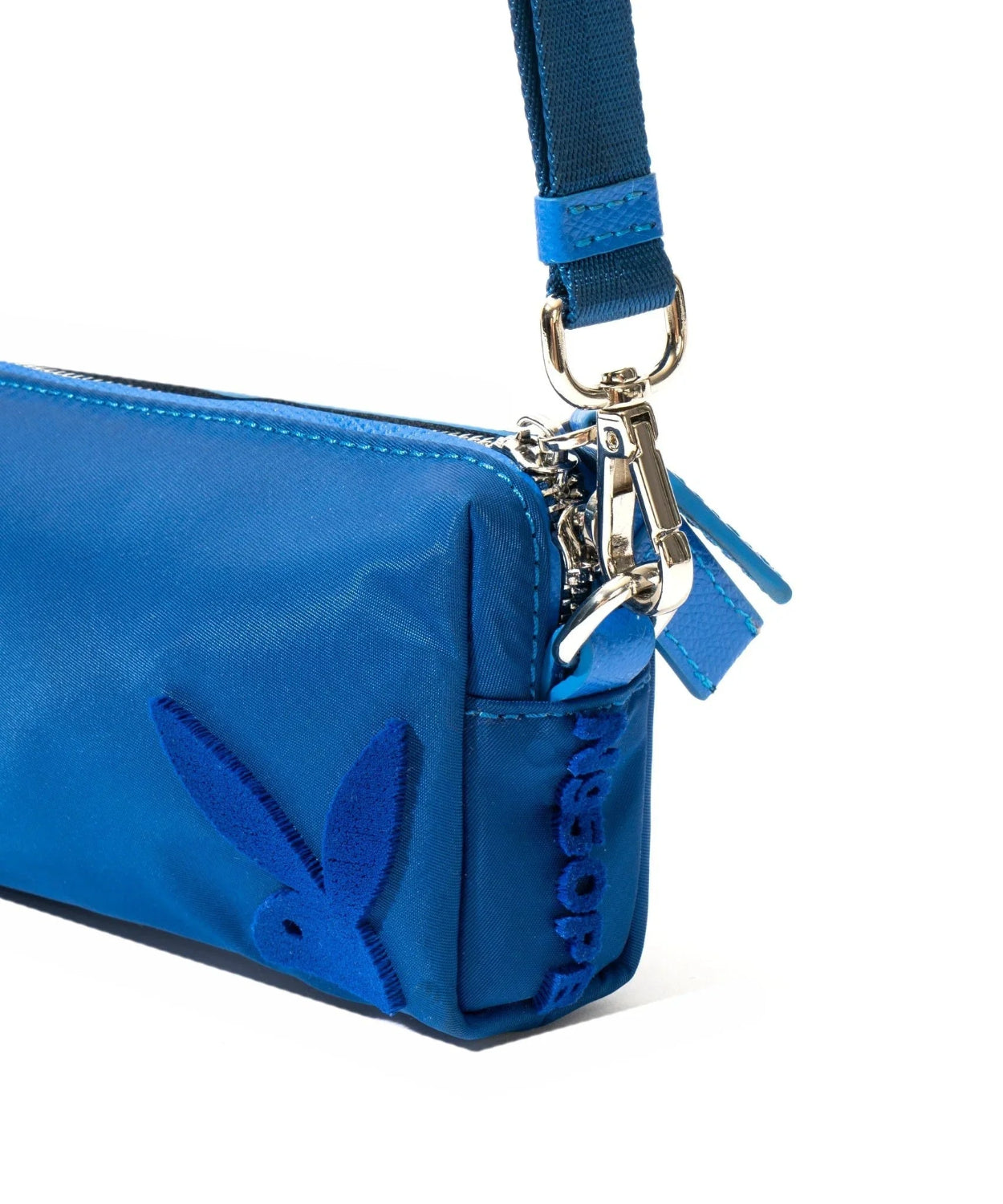 Blue nylon pouch with embroidered bunny logo and adjustable strap, close-up view