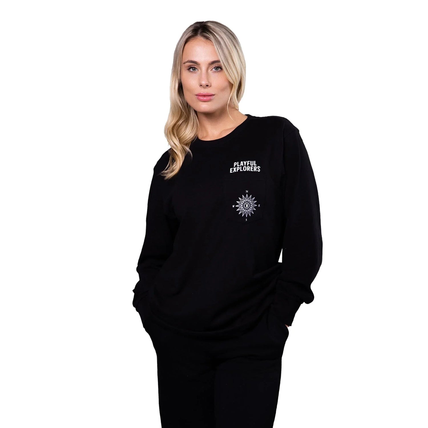 Woman wearing black long sleeve tee with 'Playful Explorers' and compass graphic on chest