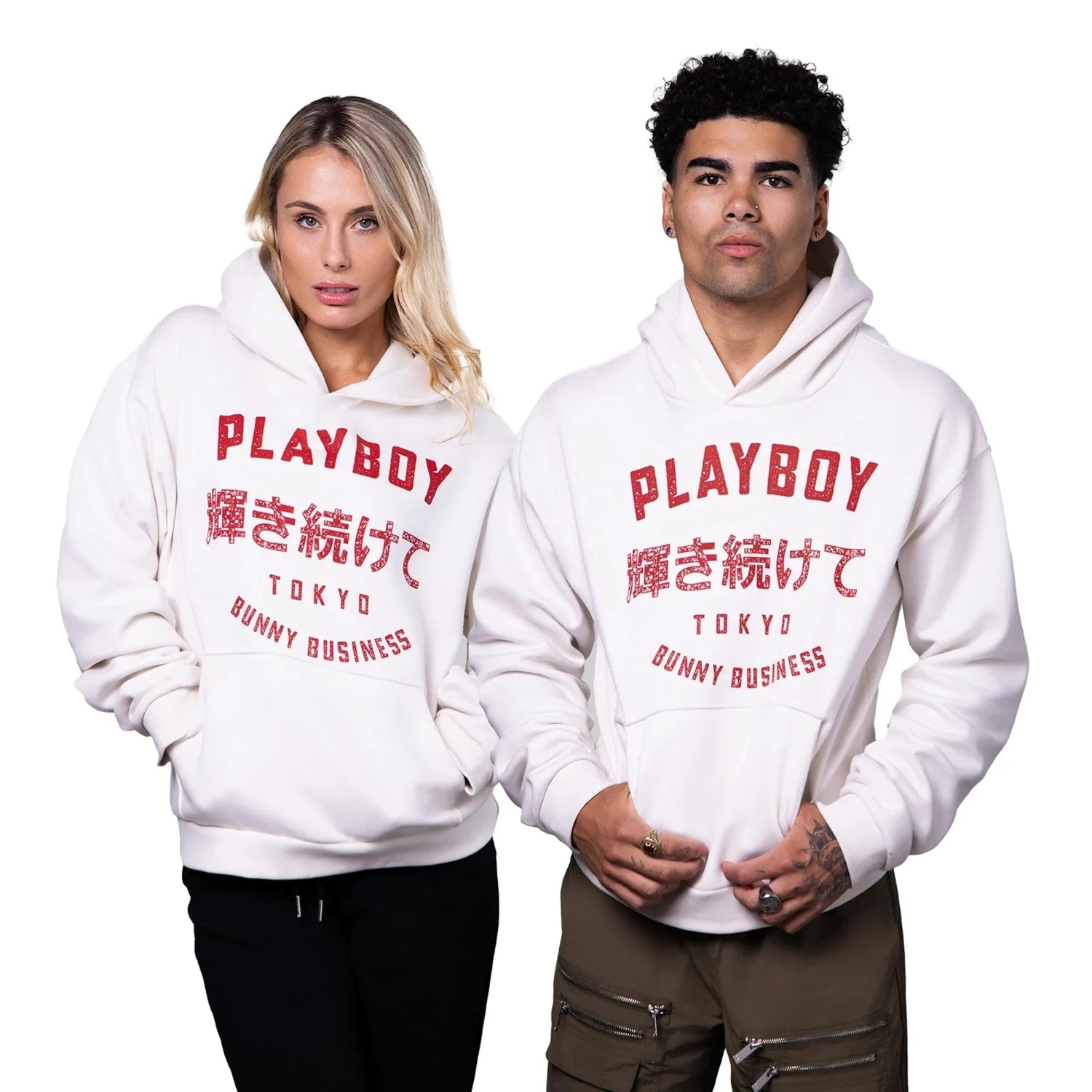 Two models wear white hoodies with red PLAYBOY Tokyo Bunny Business graphics and Japanese text.