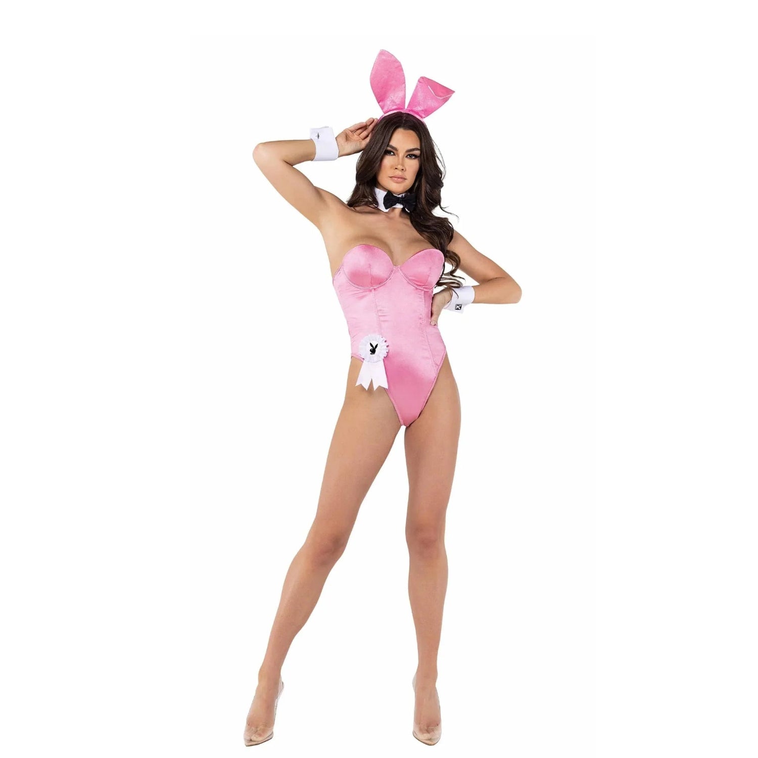 Woman in pink bunny costume set with ears, bowtie, and cuffs, white background