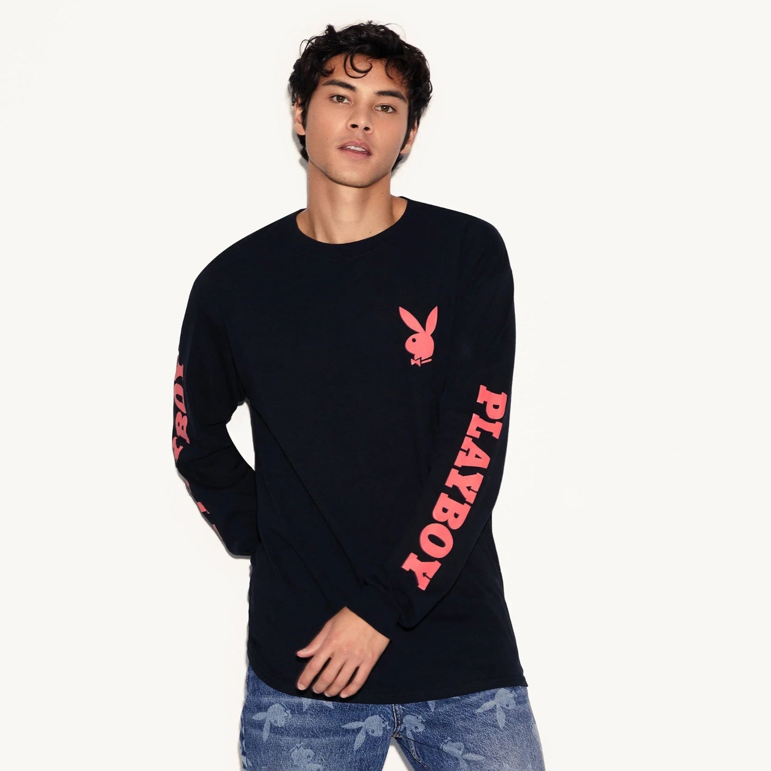 Man wearing black long sleeve t-shirt with pink rabbit logo and PLAYBOY text on sleeves