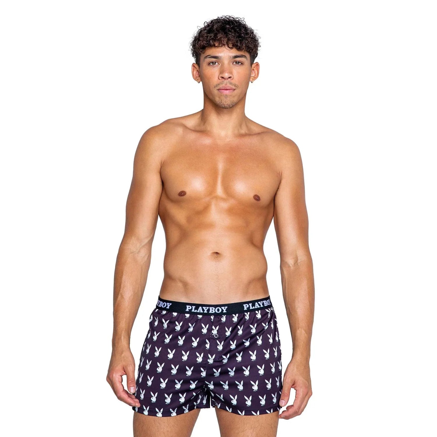 Male model wearing black men's boxer shorts with white bunny logo print and PLAYBOY waistband
